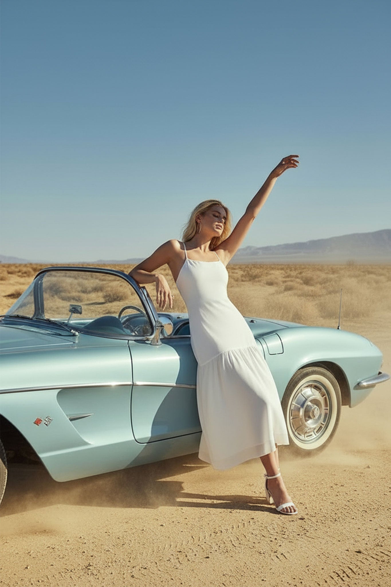 Détail de la robe blanche à bretelles minces, mettant en lumière sa jupe vaporeuse et sa texture délicate, parfaite pour...