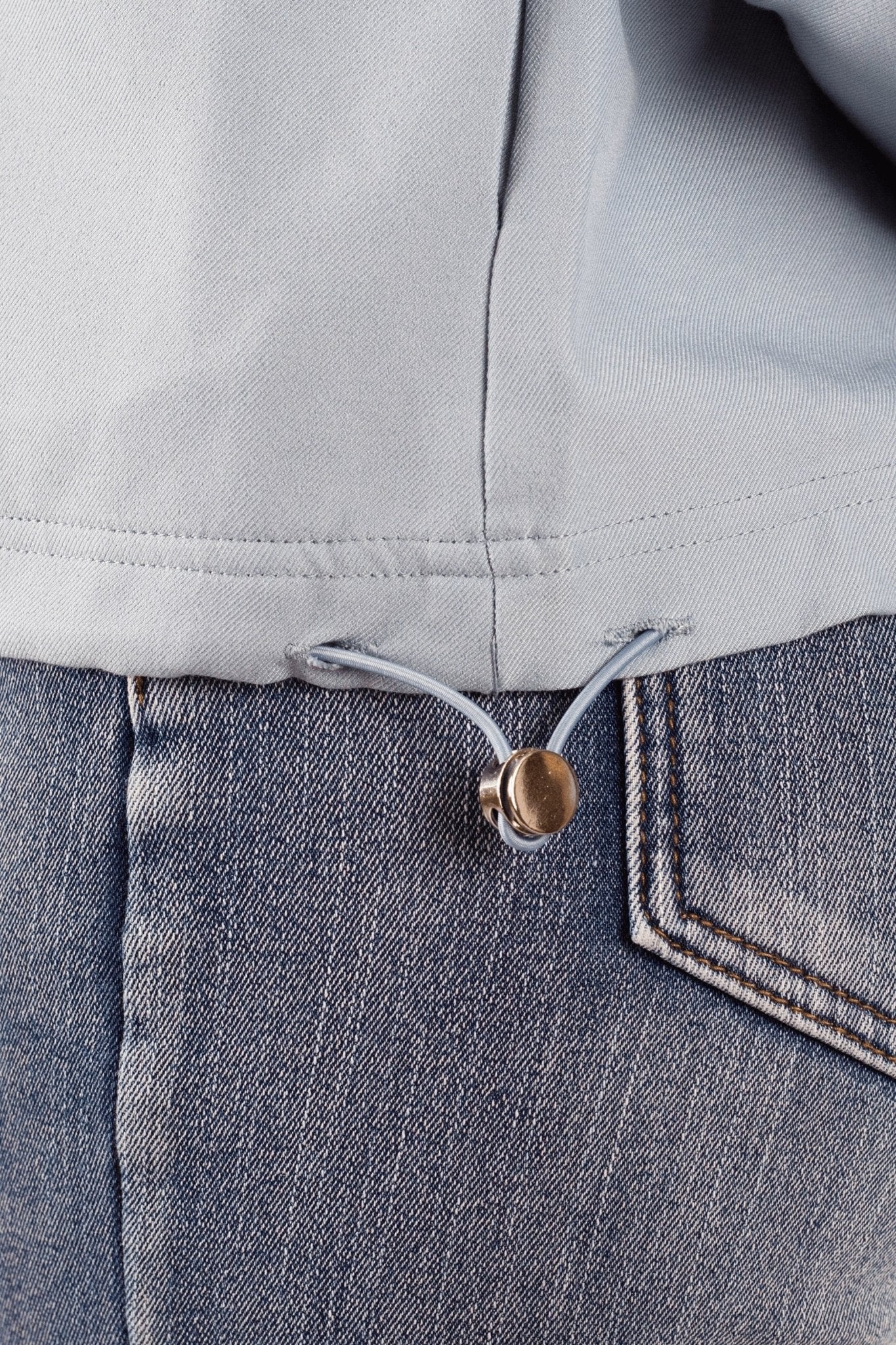 Détail texturé de la veste sport bleue à capuche, alliant confort et style pour un look chic et décontracté au quotidien.