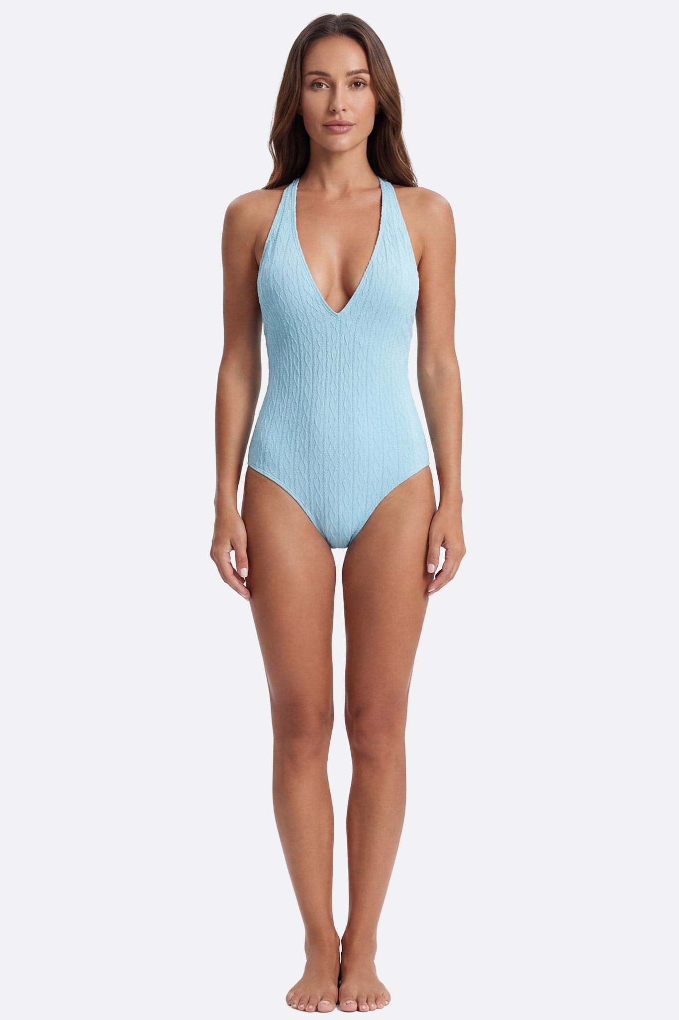 Bañador de una pieza texturizado en azul turquesa, diseñado para realzar una figura elegante y fluida.
