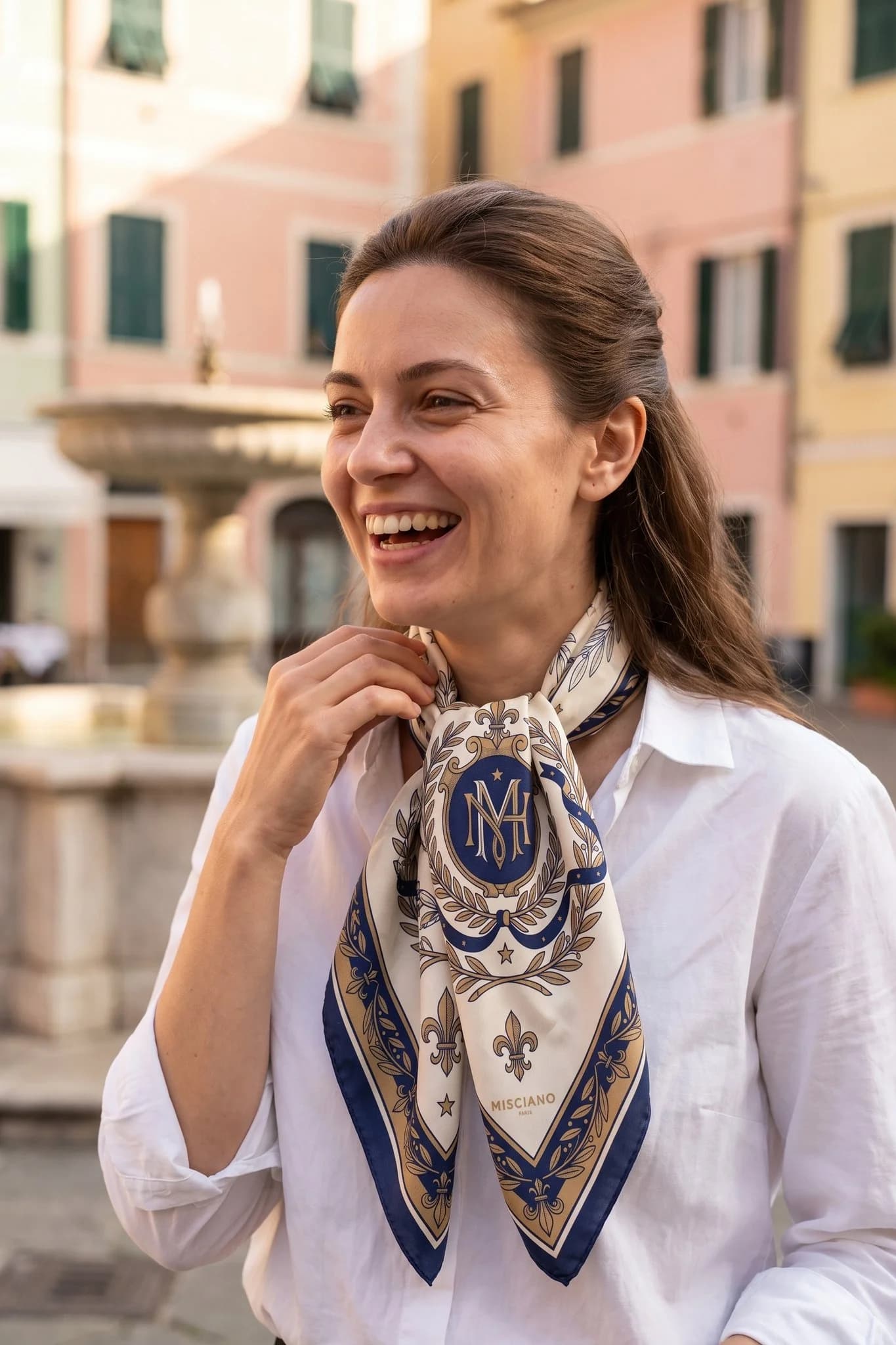 Woman wearing the Midnight Blazon silk scarf tied in a Paris street