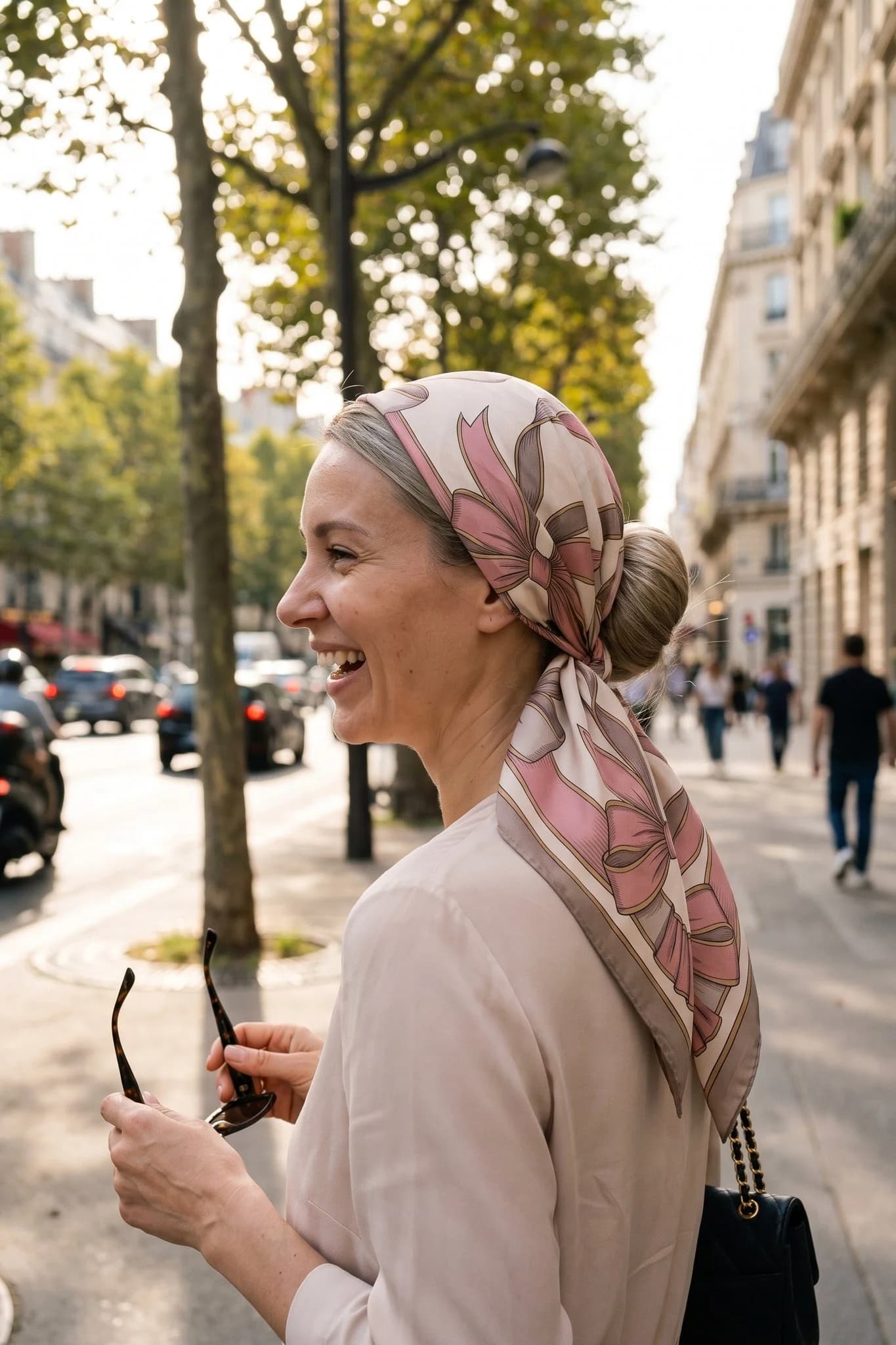 Woman wearing the silk scarf Silk ribbons as a bandana in her hair on a Paris street