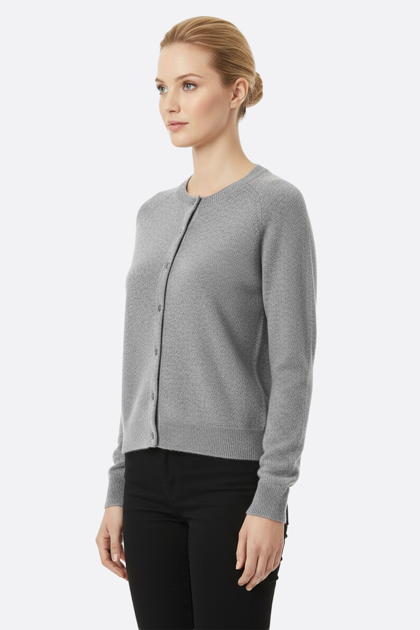 Close-up of the gray virgin wool cardigan, emphasizing the fineness of the knit and the timeless elegance of its stitching...