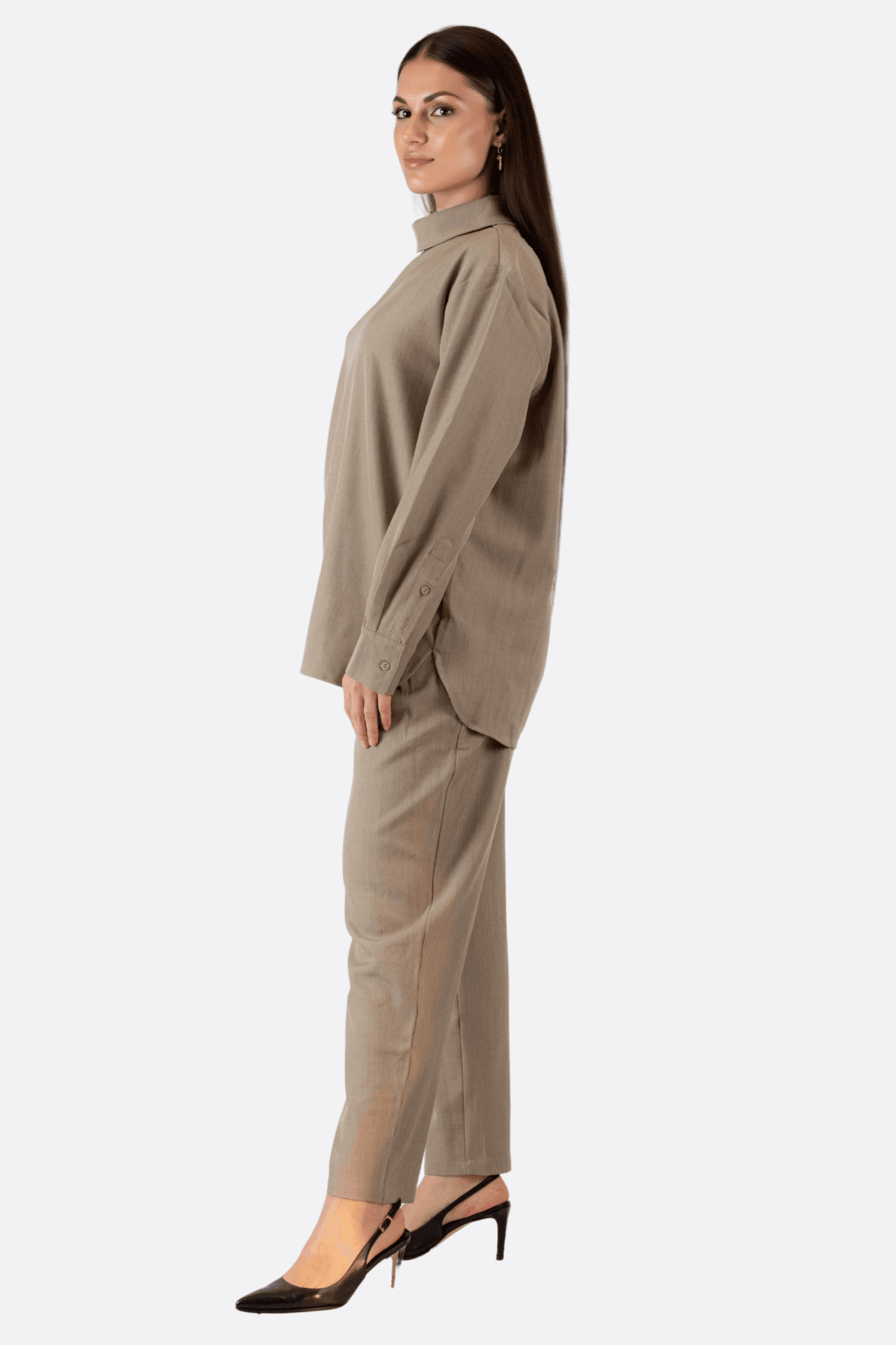 Close-up of the textured detail of the coordinated gray two-piece set, combining wide pants and elegant shirt for a...