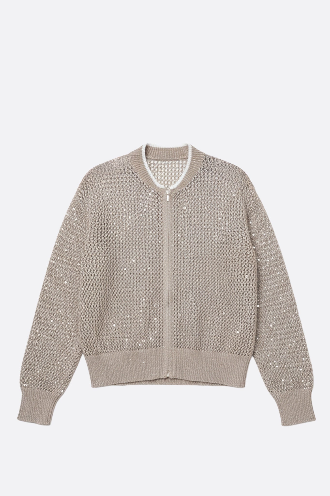 Detalle lateral del chaleco beige arena con cremallera, de algodón y tencel calado, adornado con lentejuelas, ideal para un look chic en...