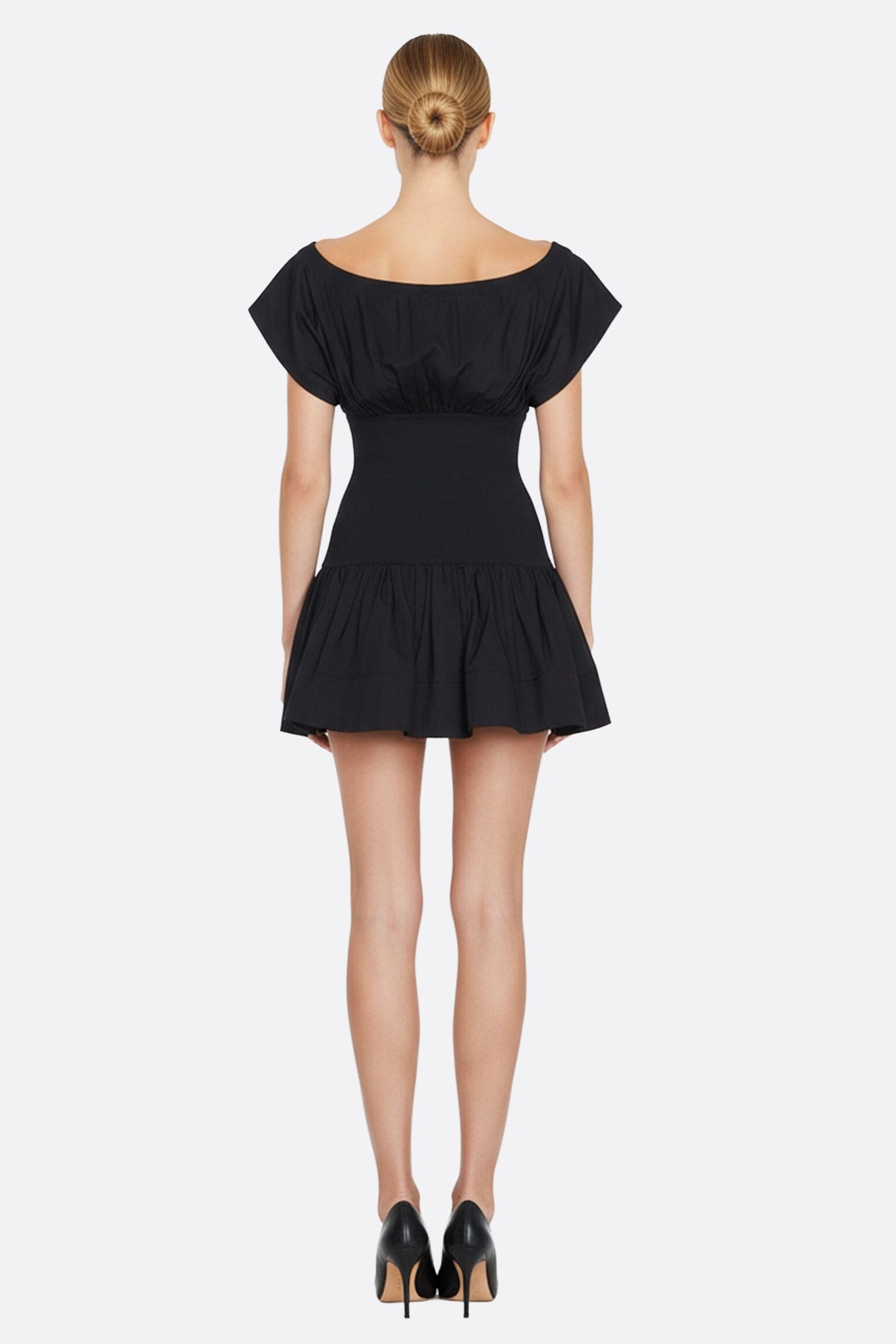 Back detail of the short black dress adorned with delicate butterfly sleeves, ideal for a glamorous evening.