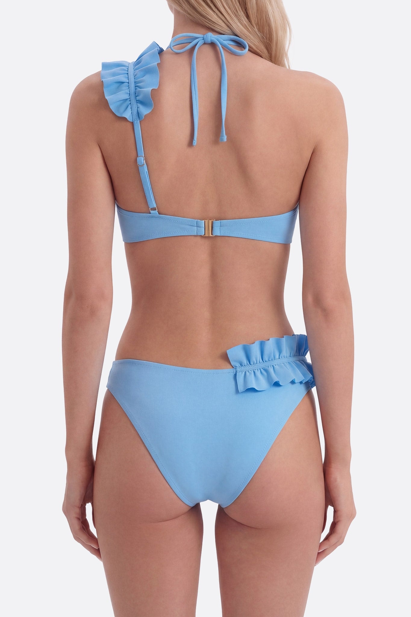 Side view of the pastel blue bikini with ruffles, adding a fresh touch for relaxing moments in the sun