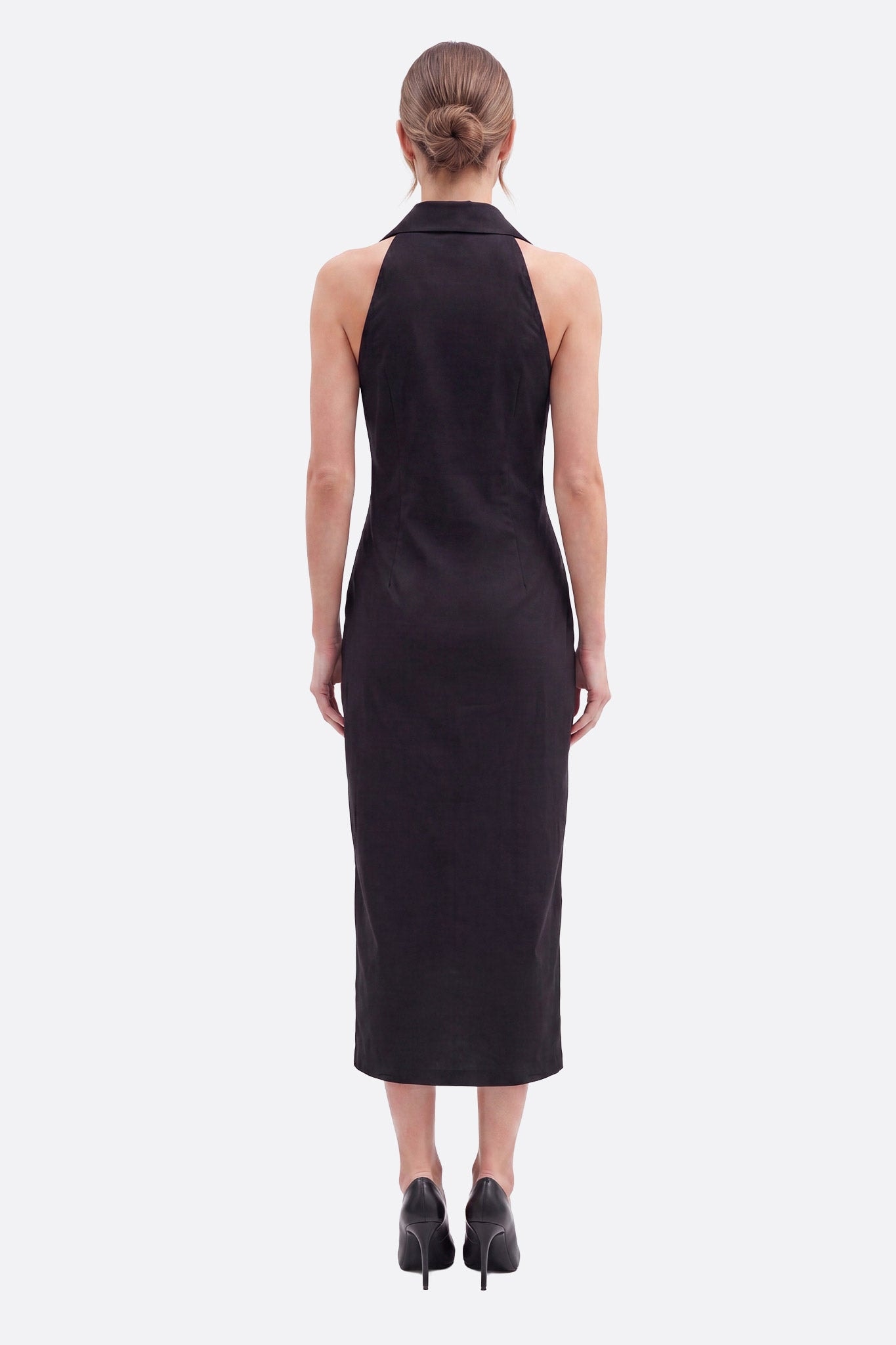 Model in schwarzem Midikleid mit Hemdkragen, Rückansicht, taillierter Schnitt und fließender Stoff