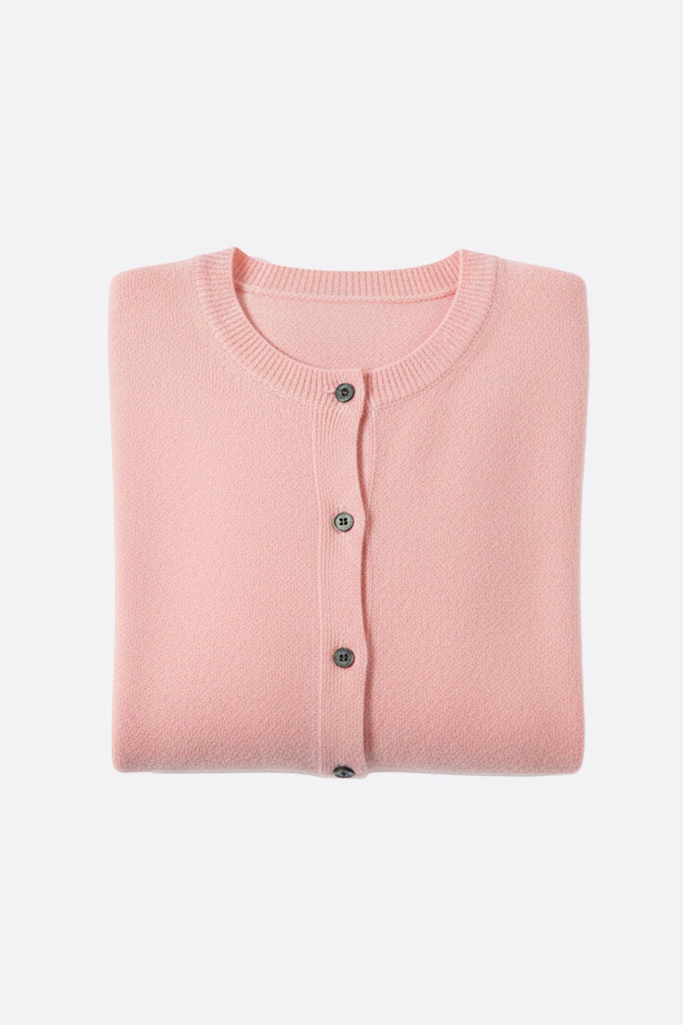 Side view of a powder pink wool cardigan, highlighting the fineness of the knit and its chic look for...