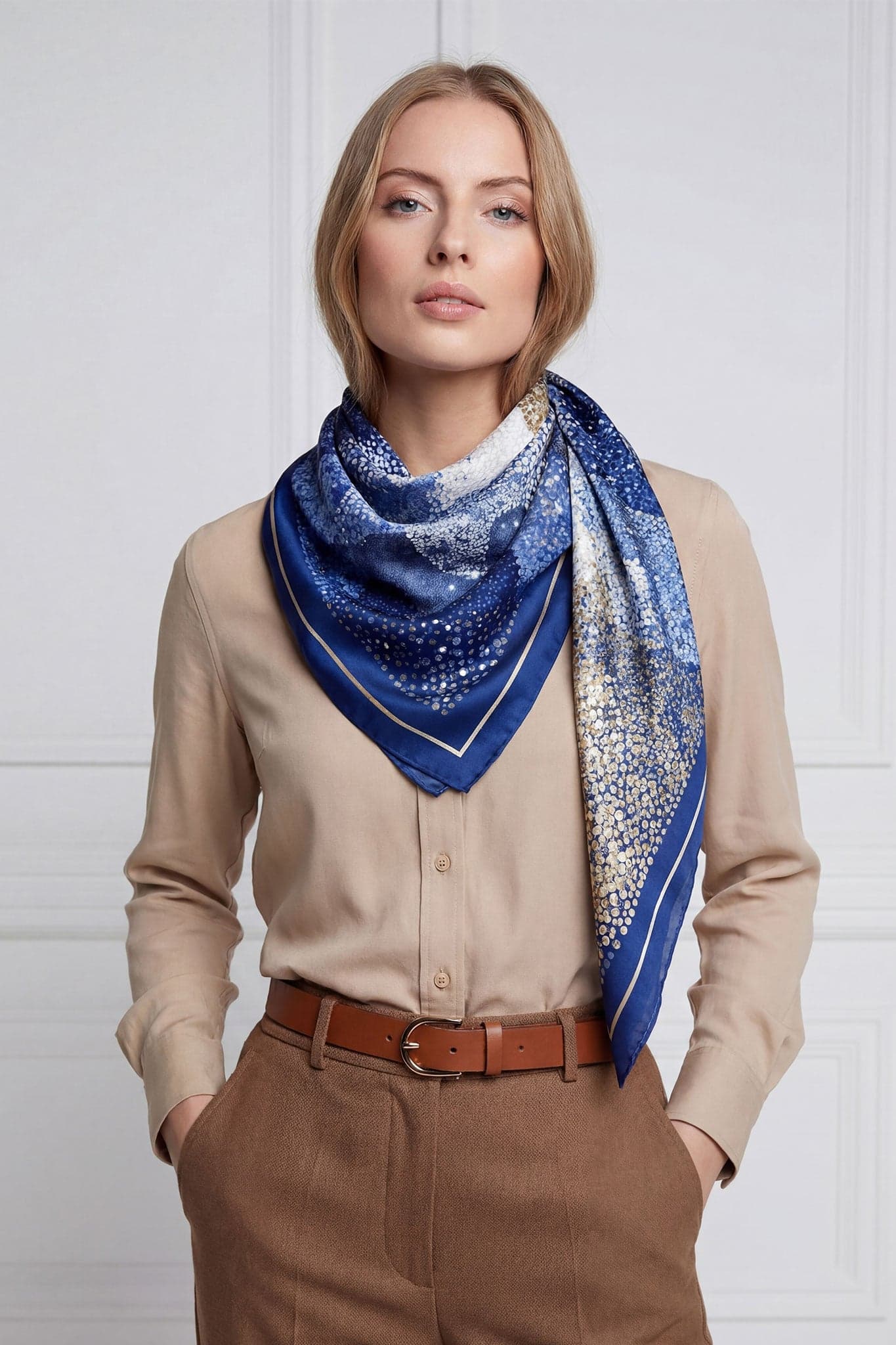 Unique angle of the double-sided Mosaïque Nocturne silk scarf, featuring deep blue tones adorned with shimmering gold and...