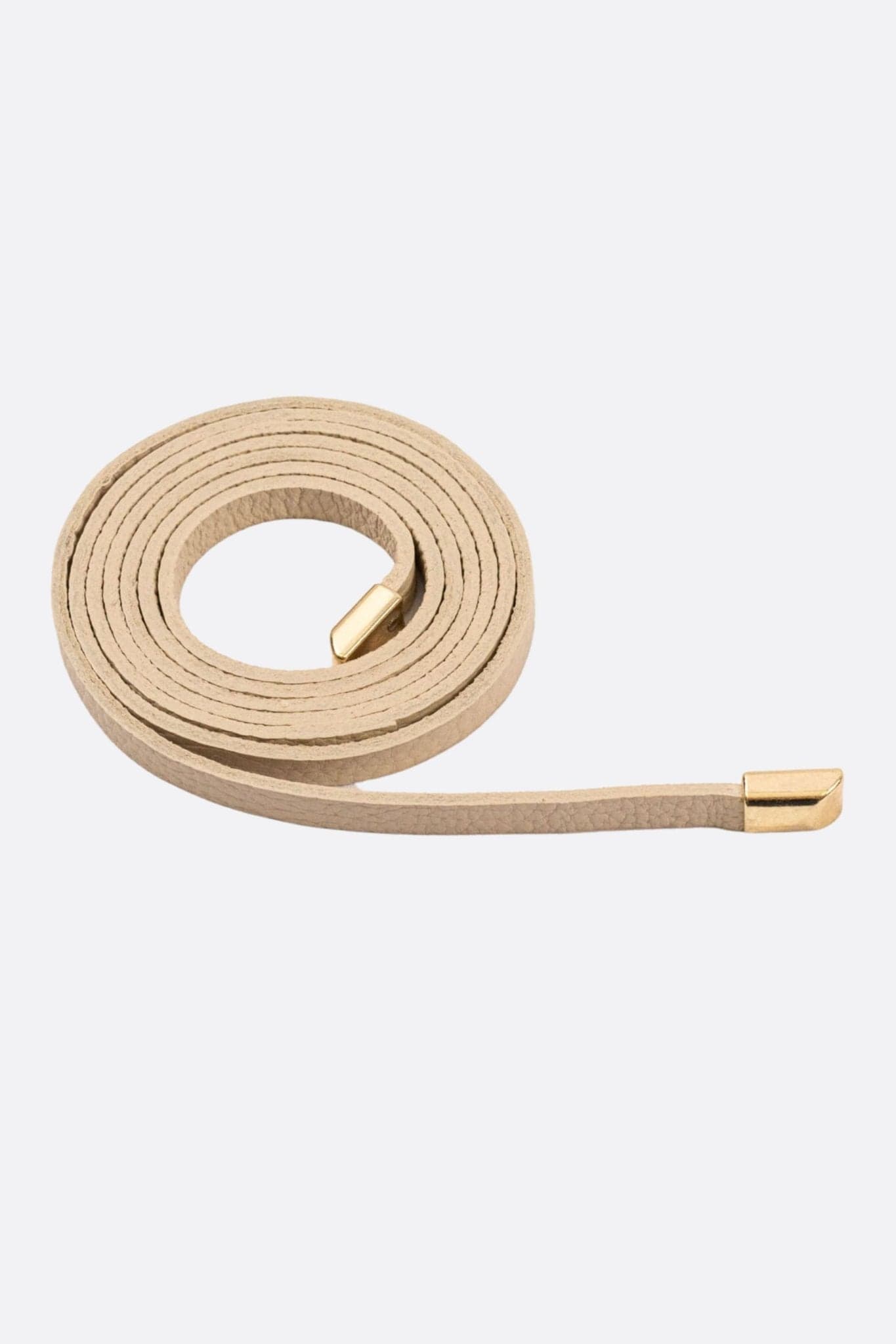 Ceinture délicate en cuir beige avec embouts dorés, idéale pour sublimer une tenue élégante ou décontractée.
