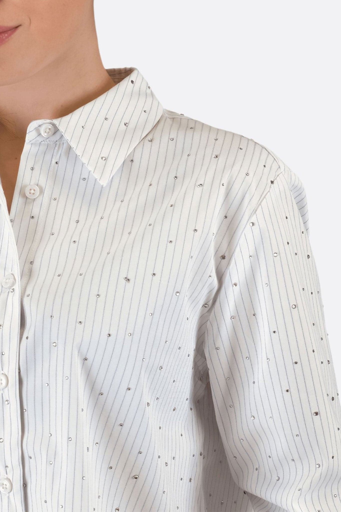 Detailed view of the white cotton shirt adorned with fine stripes and crystals, perfect for an elegant look at...