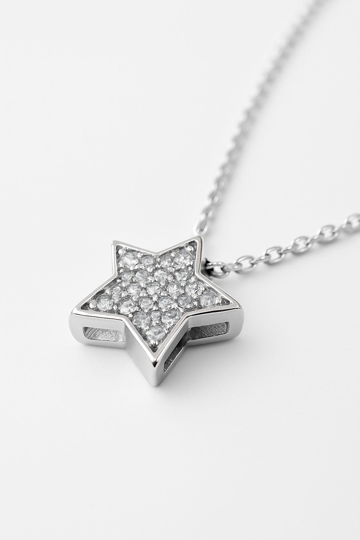 Close-up on the 925 silver star pendant, delicately paved with crystals, adding a refined touch to your look