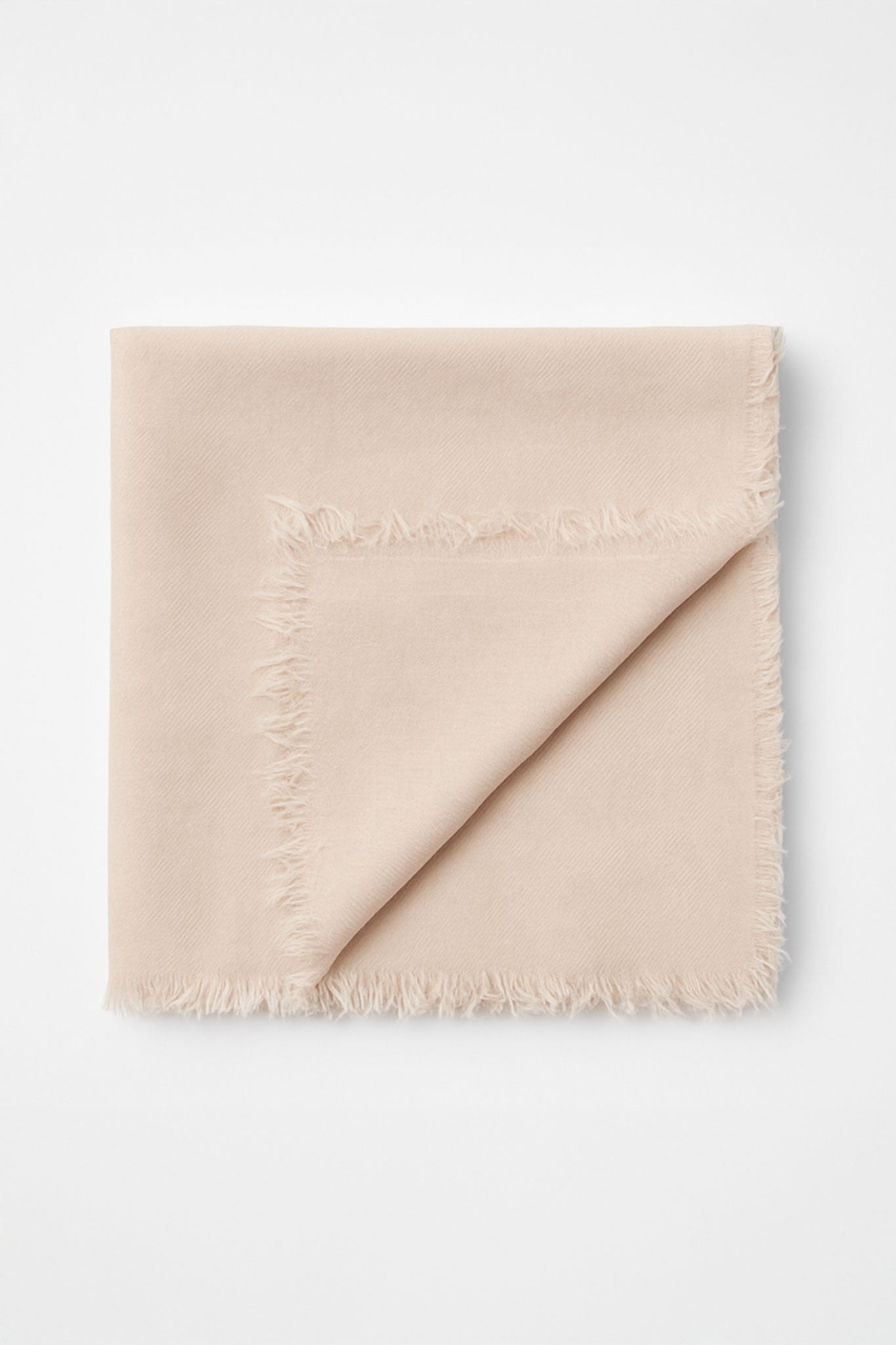 Elegant blush scarf in natural fabric blend, showcasing its luxurious softness and refined draping for sophisticated styling.
