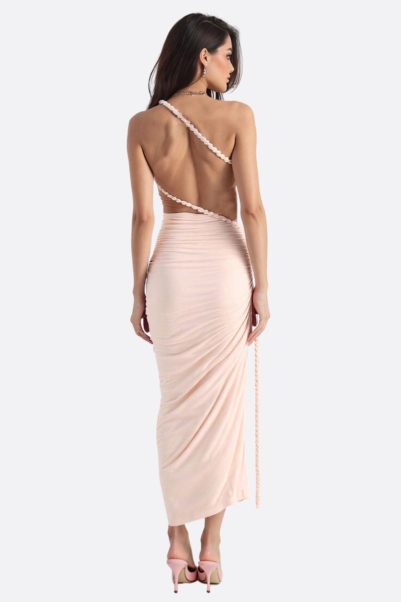 Detail of the back of the pastel pink beachwear set, highlighting its fluid drape and sophisticated allure.