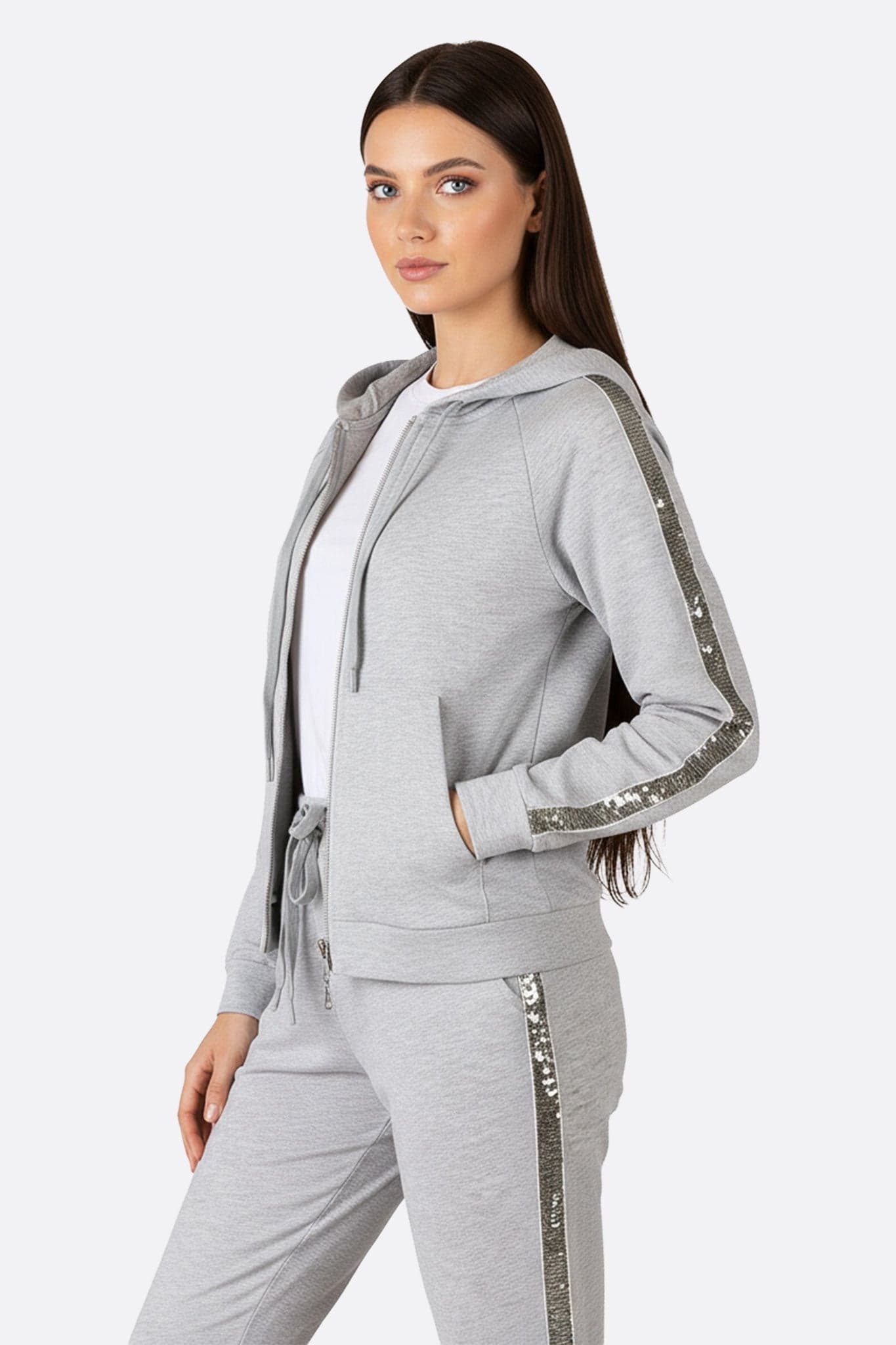 Captivating details of the pearl grey tracksuit, showcasing the sequin stripes for a chic style...