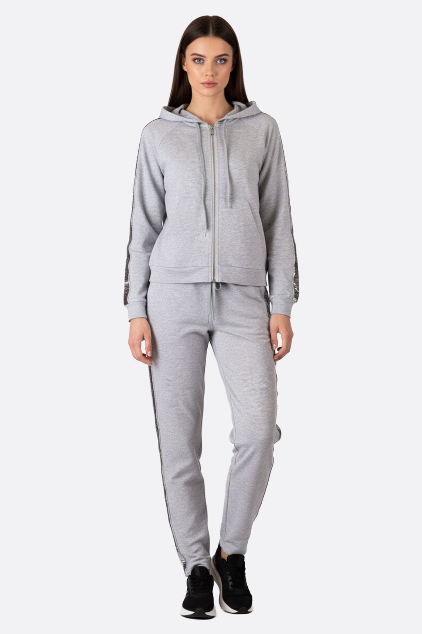 Close-up view of the pearl grey tracksuit, highlighting the sparkling sequin stripes for a look...