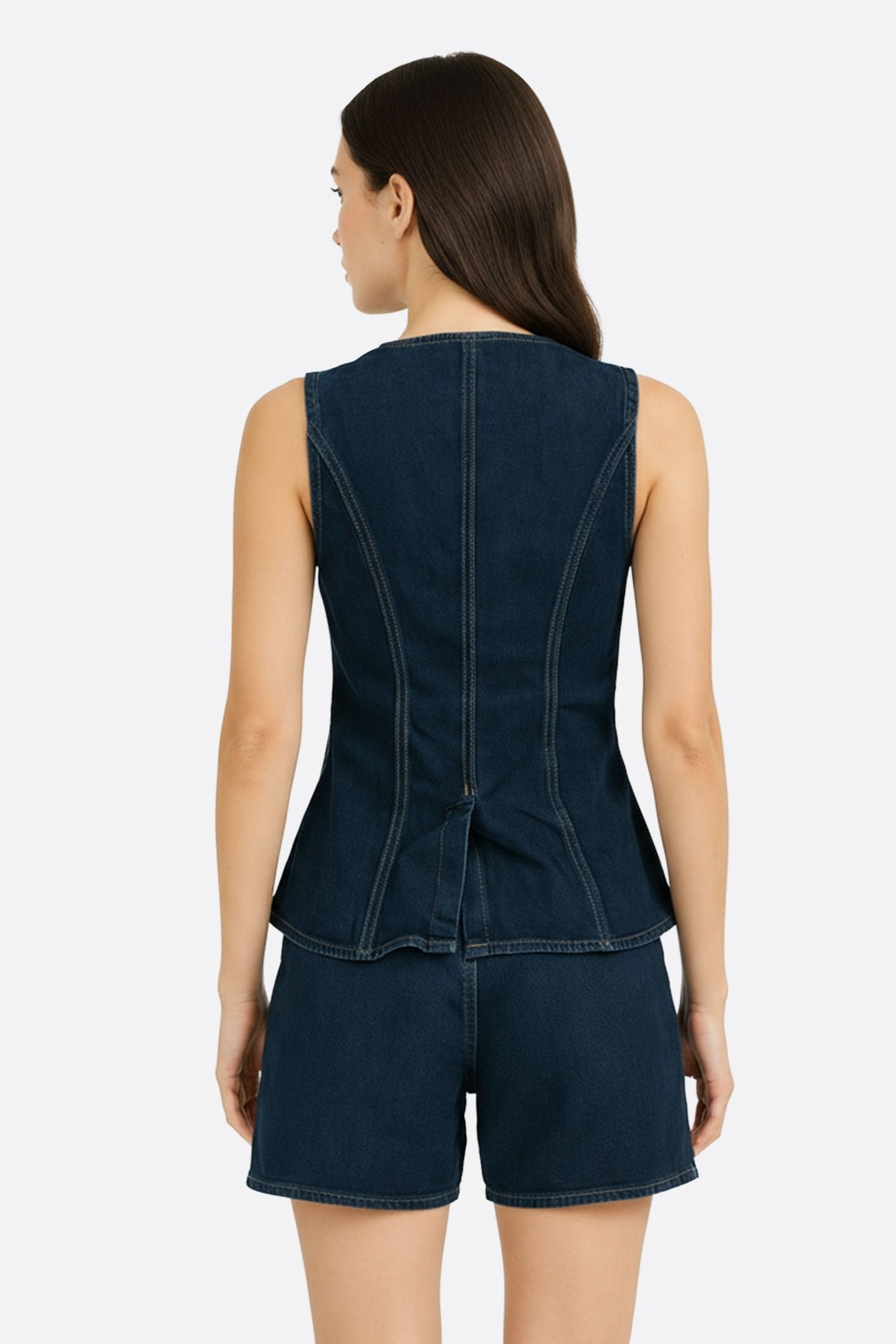 Elegant detail of a fitted sleeveless denim vest, perfect for a refined, contemporary look