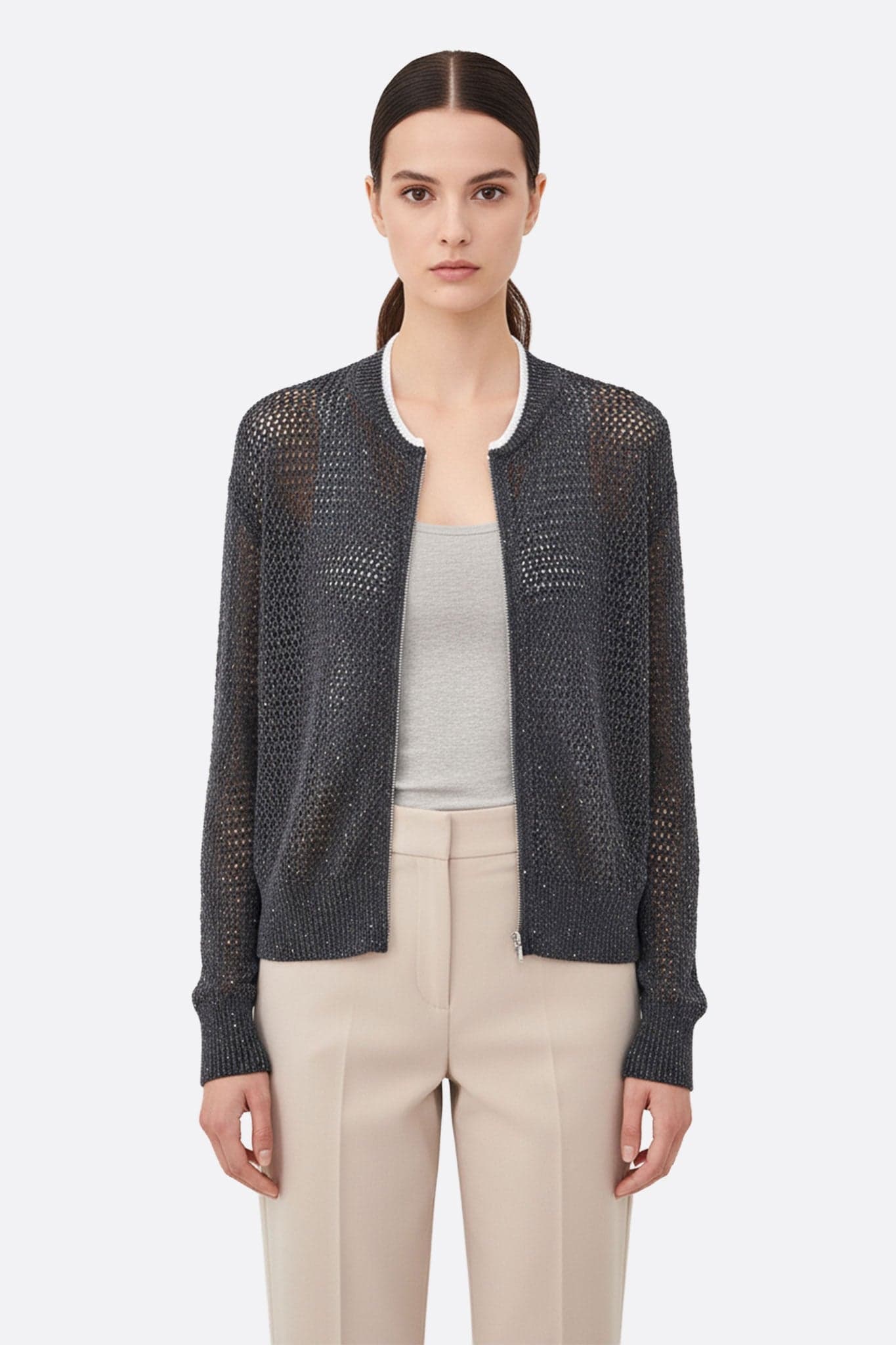 Detail of the zipped vest in grey openwork, combining cotton and tencel, adorned with sequins, ideal for a chic everyday touch.
