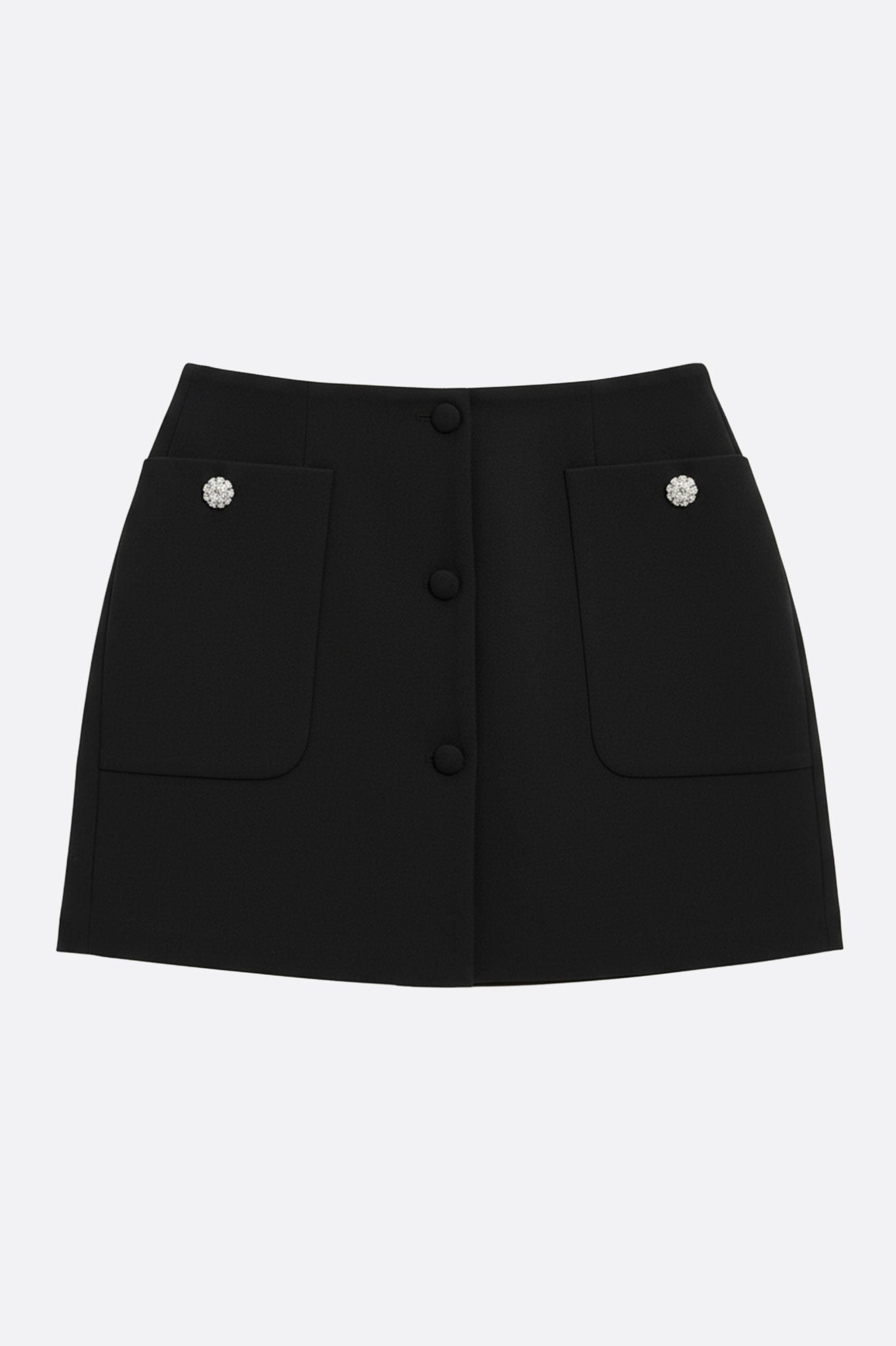 Black skirt with wide pockets and jewel buttons, three-quarter view, emphasizing its straight cut and chic allure for all...