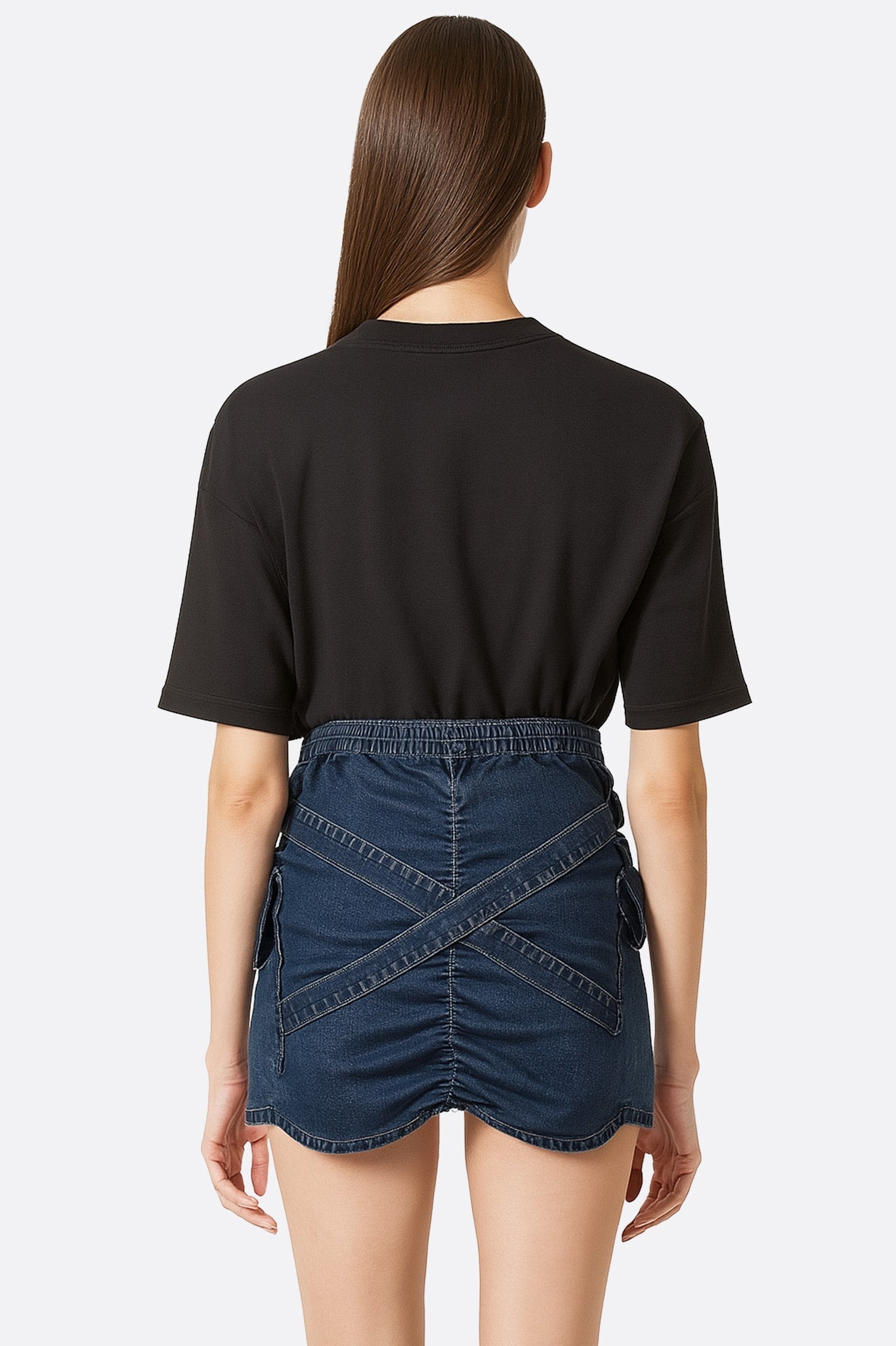 Close-up on the texture of the structured denim and the crossed straps of this bold and elegant skort.