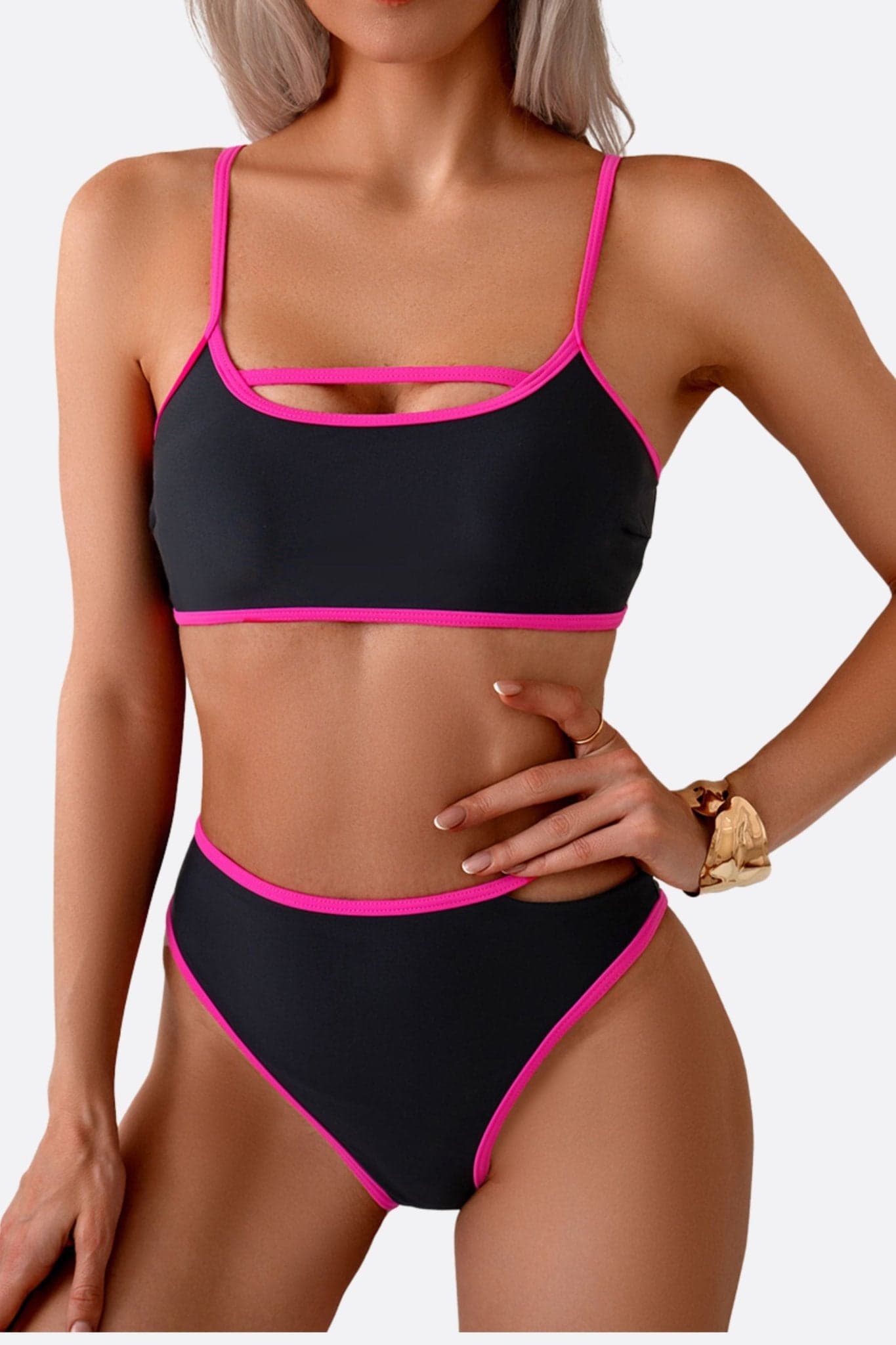 Black high-waisted bikini with fuchsia touches, a bold piece to enhance your silhouette with elegance.