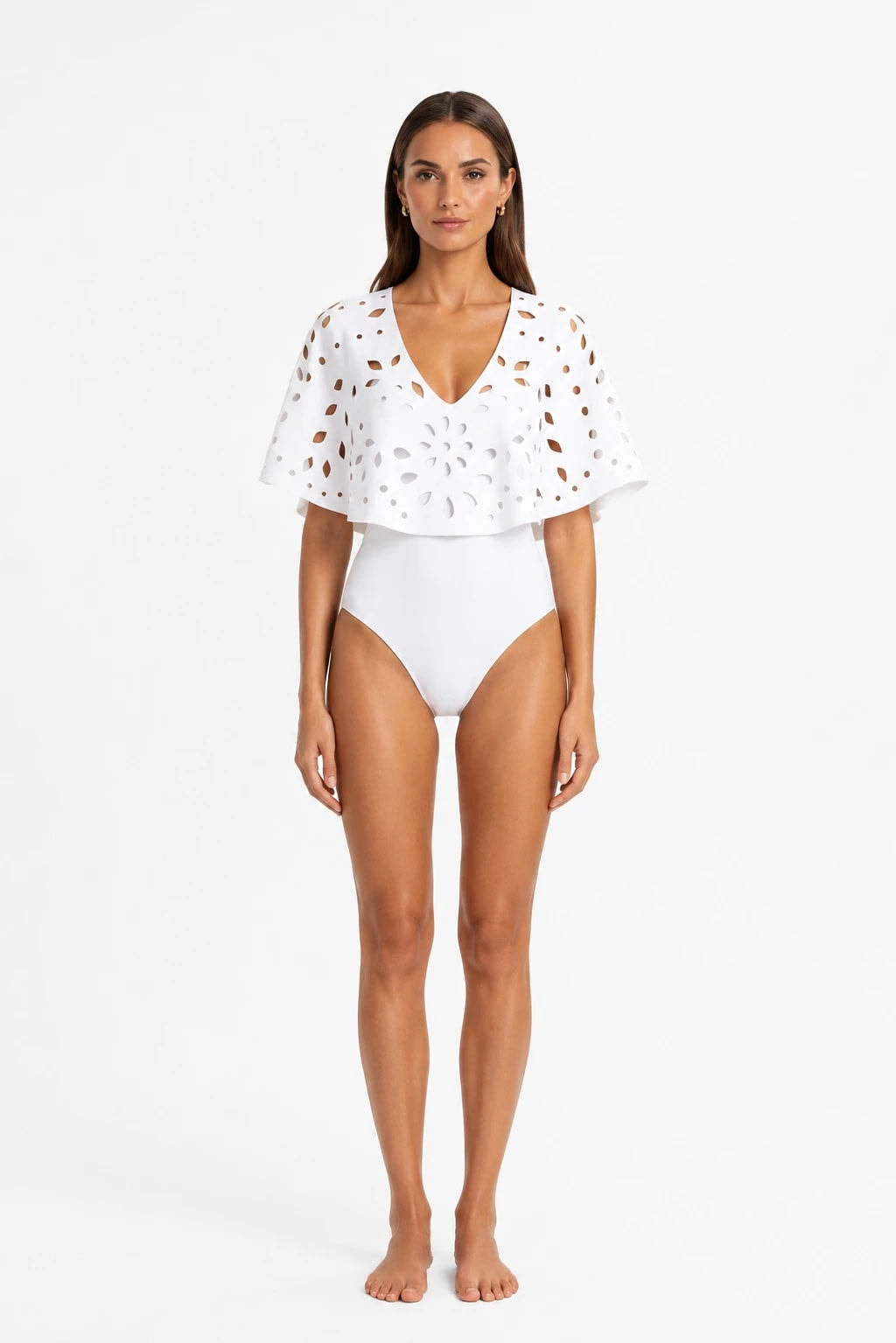 White one-piece swimsuit with openwork cape, worn front view by a woman