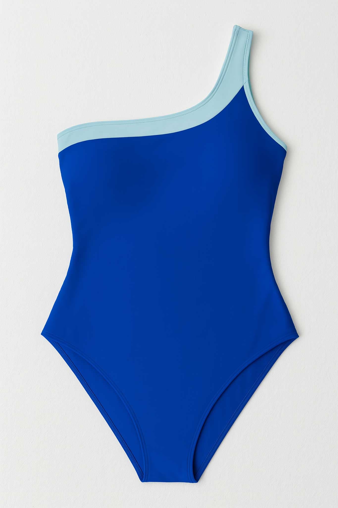 Texture detail of the blue one-piece swimsuit, asymmetric design with contemporary style, ideal for summer.