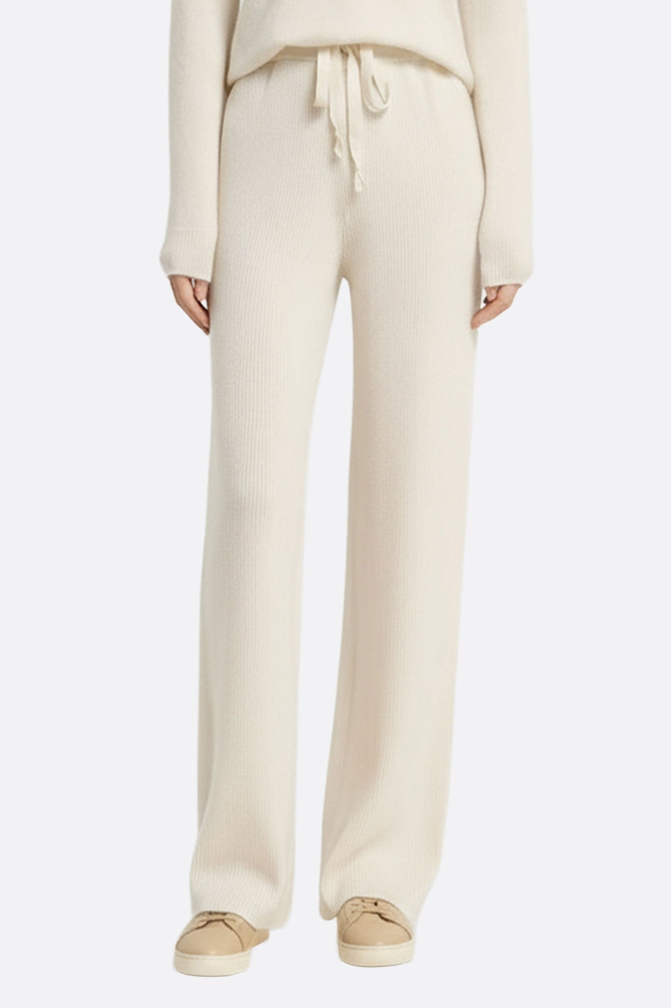Pantalon en laine blanche à taille élastique, coupe fluide pour une allure chic et intemporelle en toute occasion.