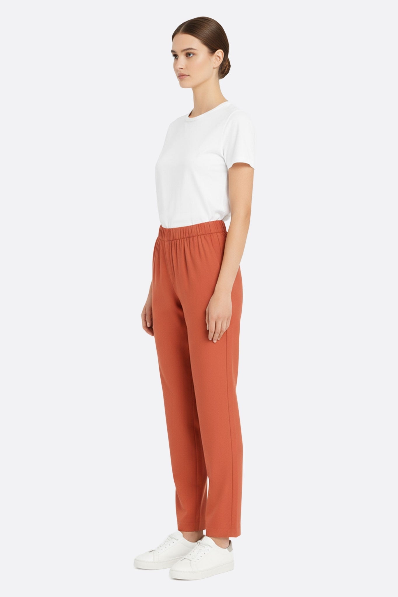3/4 detail of the flowing terracotta linen trousers, perfect for a chic and casual look at summer events.