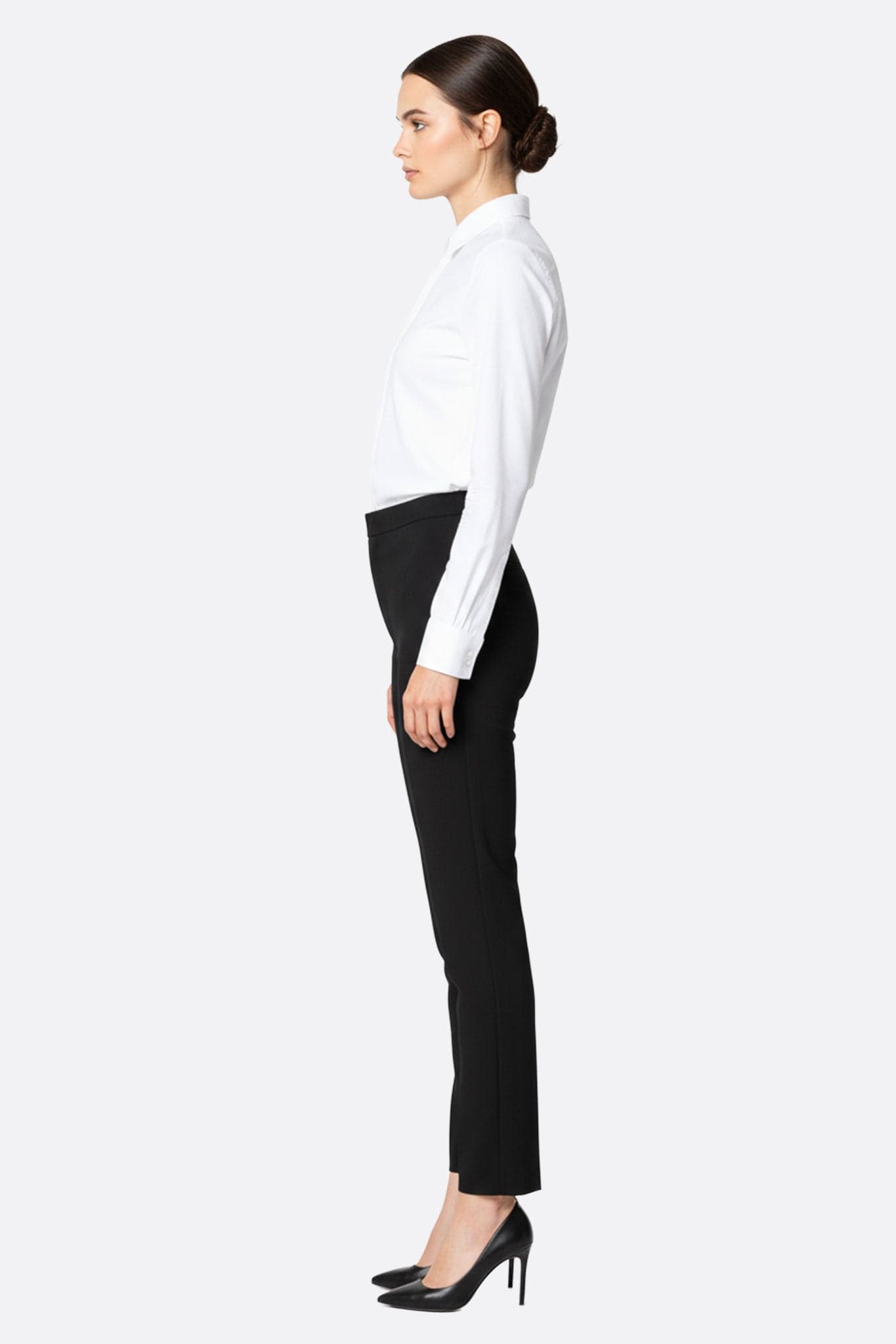 Detail of the classic black straight-leg trousers, an essential piece for an elegant style at the office or during...