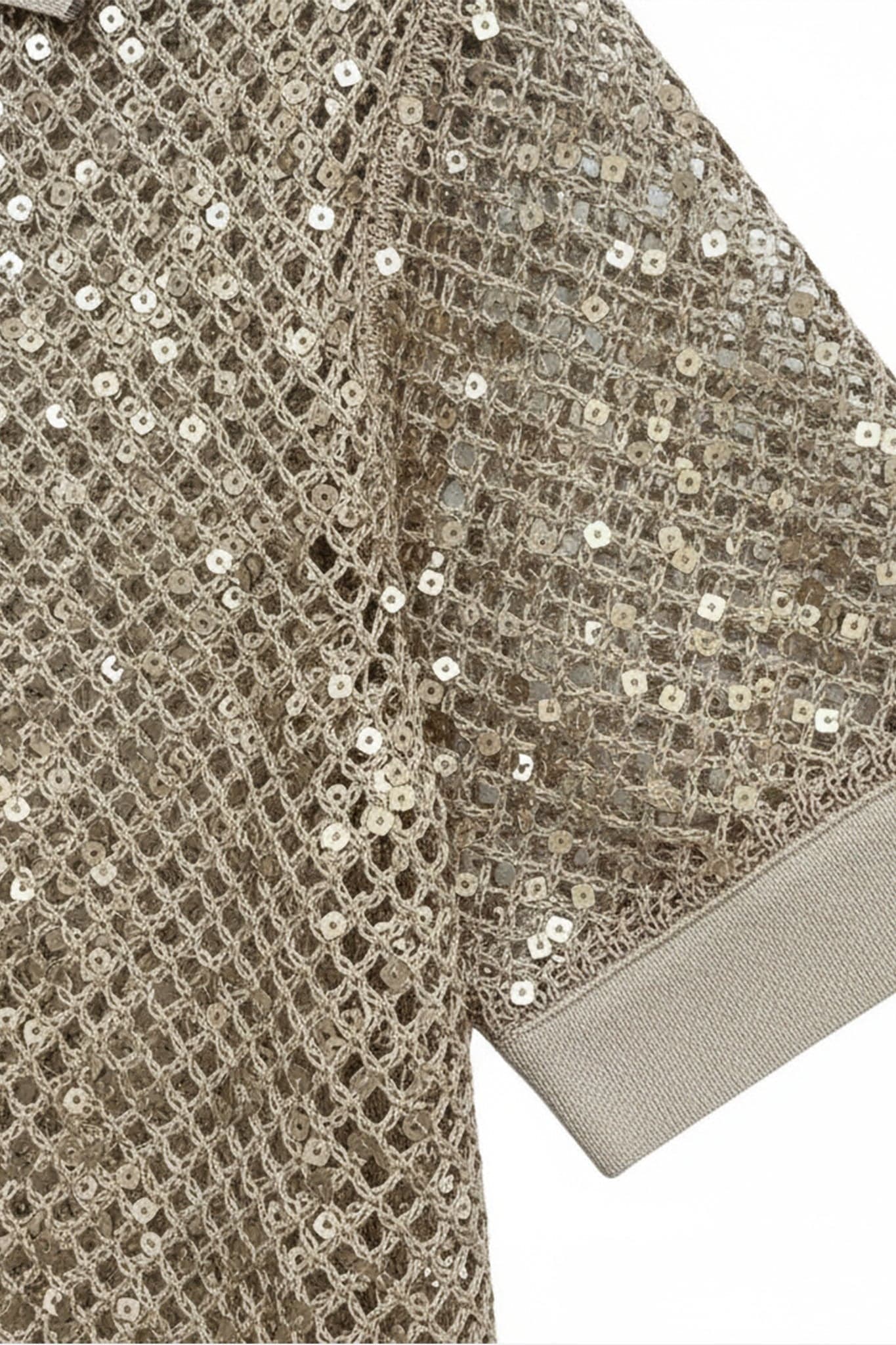 Captivating detail of a sand beige knit polo, adorned with tone-on-tone sequins, perfect for a chic summer outing.