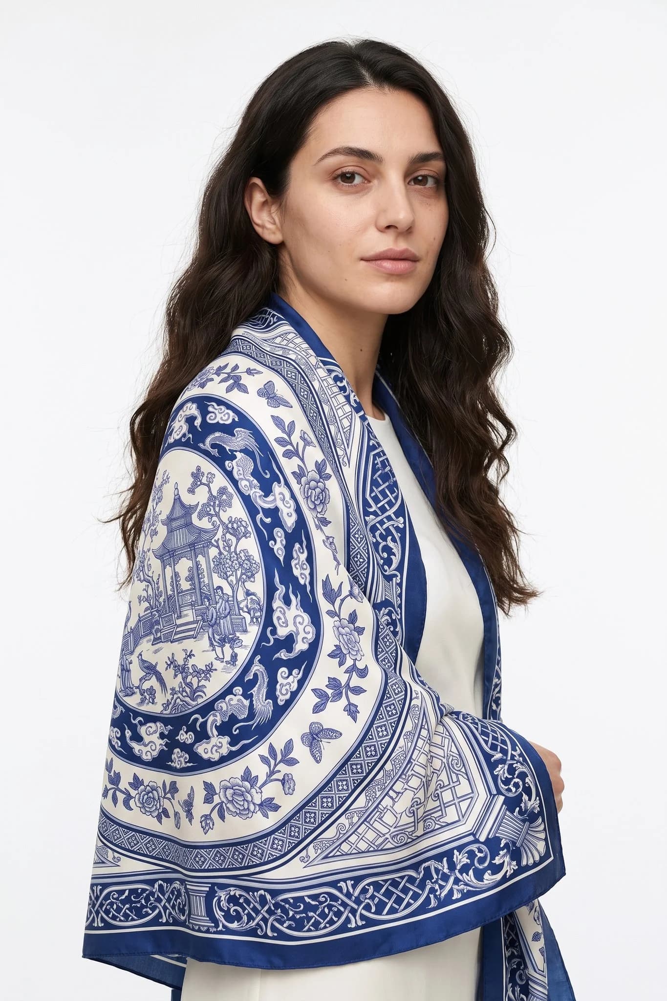 Large 110 silk scarf Grande porcelaine worn as a stole over a woman's shoulders, studio view
