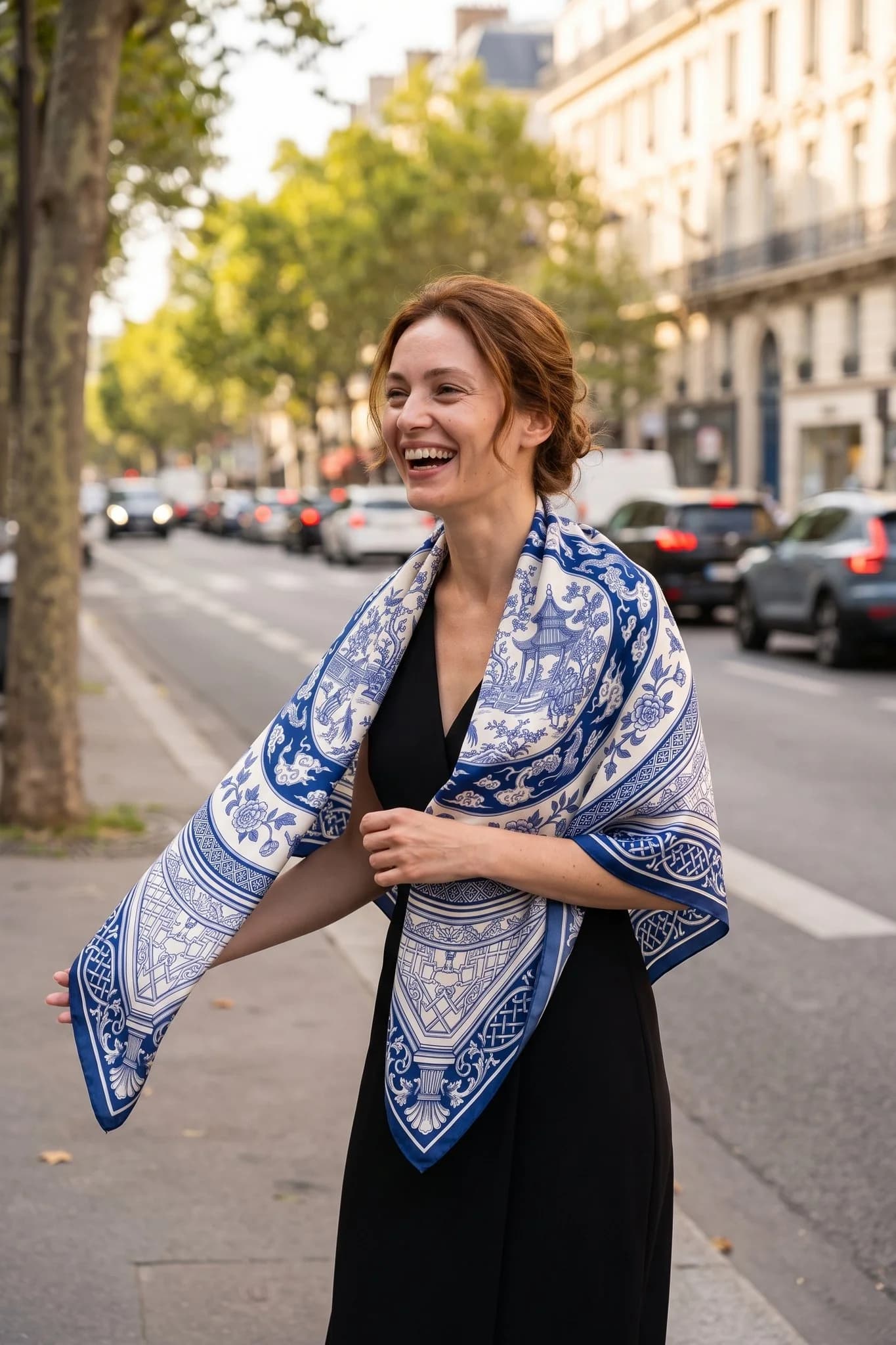 Woman wearing the silk scarf Grande porcelaine as a shawl in a Paris street