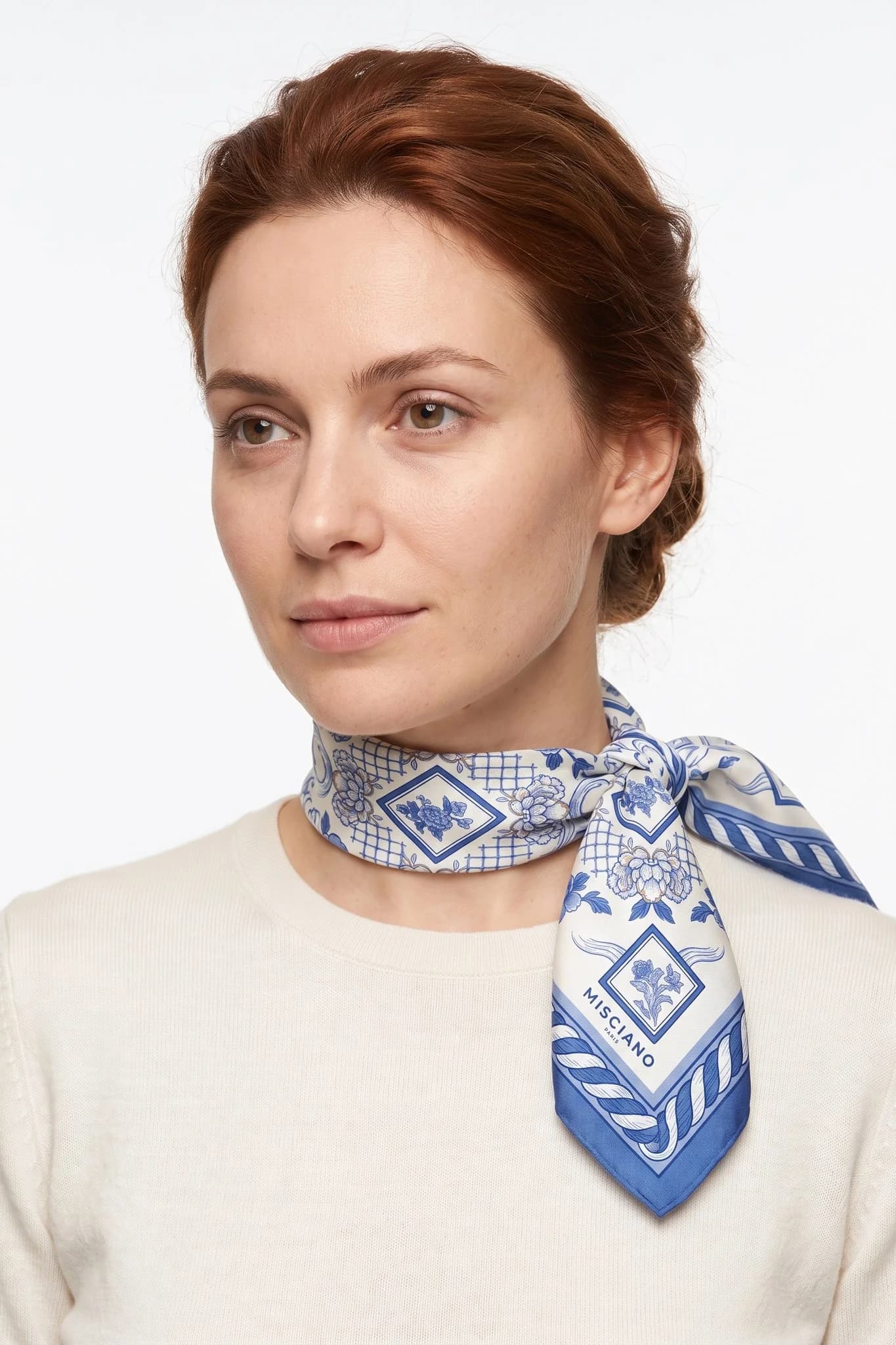 Small silk scarf 50 Camaïeu de porcelaine worn tied around the neck as a small scarf by a woman, studio view