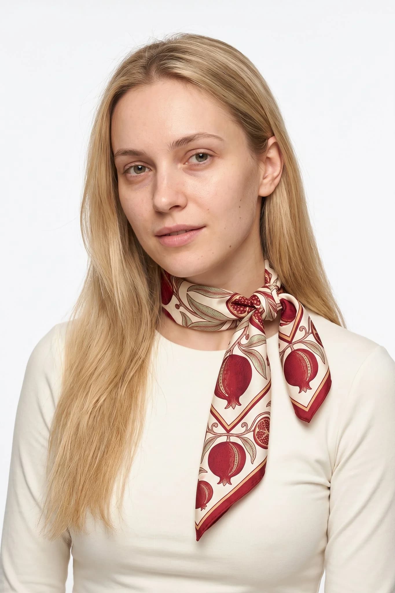 Small silk scarf 50 Golden Pomegranates worn tied around the neck as a small scarf by a woman, studio view