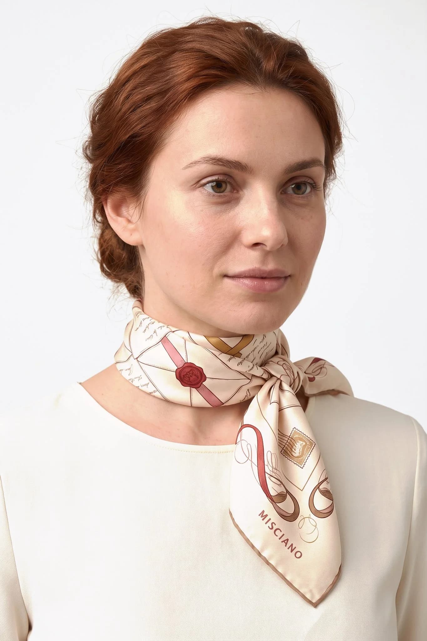 Small silk scarf 50 Love Letters worn tied around the neck as a small scarf by a woman, studio view