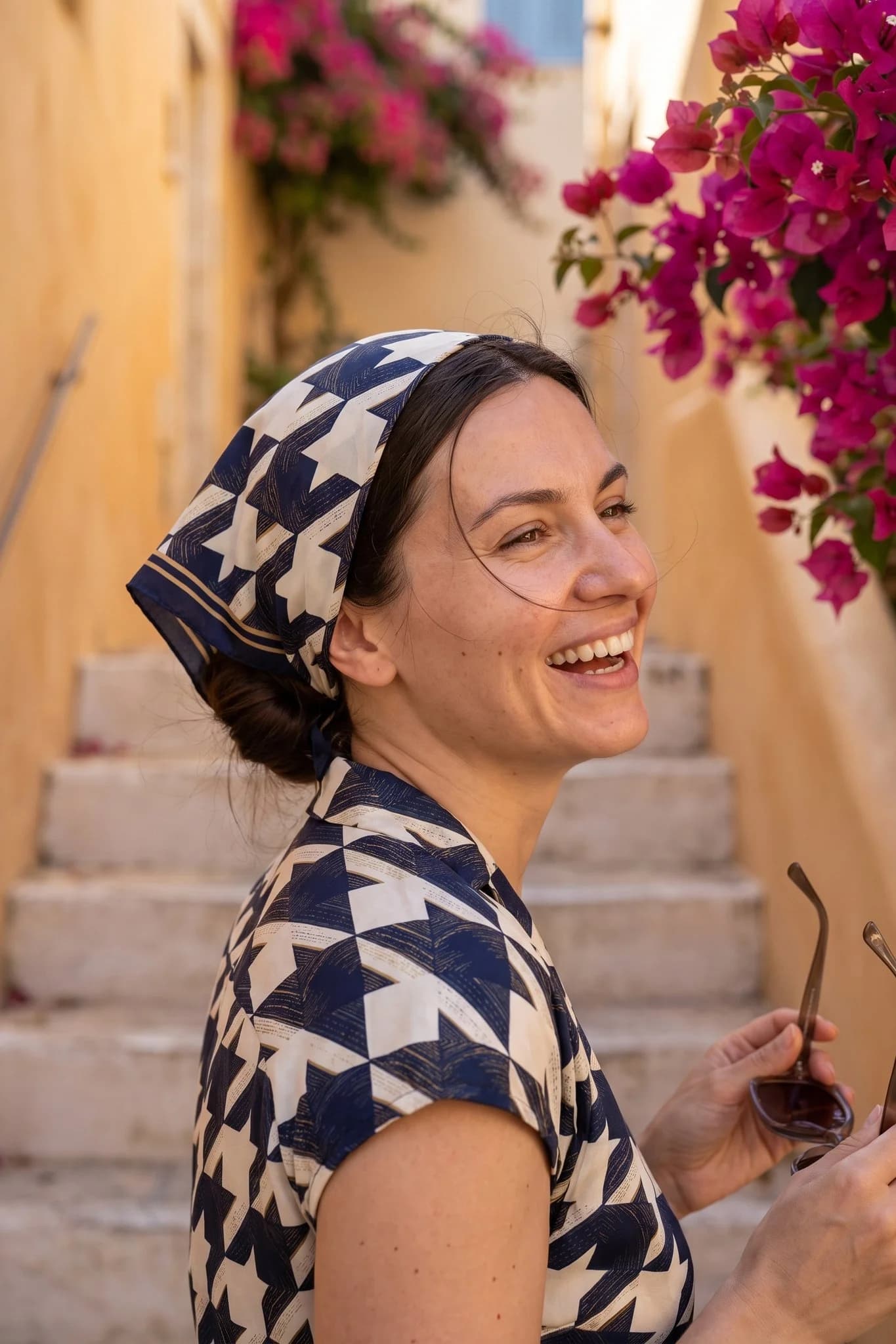 Woman wearing the Parisian houndstooth silk square as a bandana in her hair on a Paris street