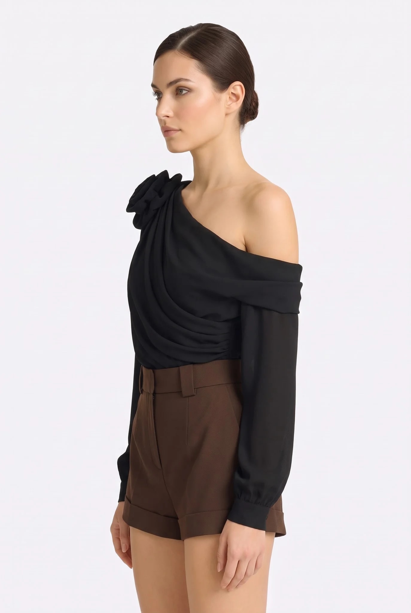 Profile of the black draped Misciano top, relief of the sculpted flower on the left shoulder