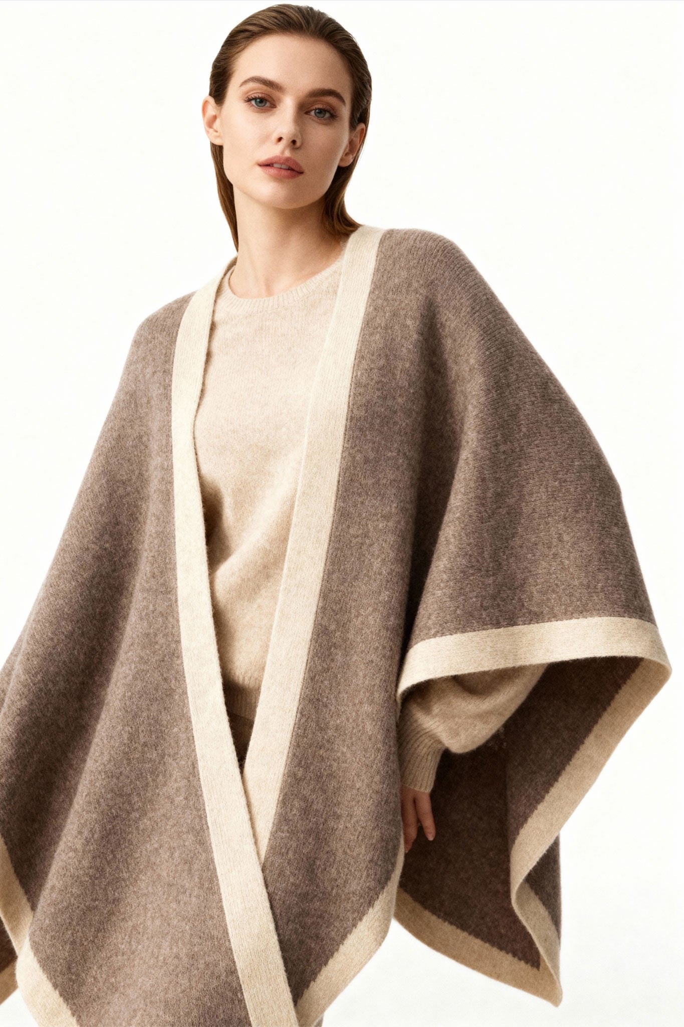 Luxurious texture of a taupe cashmere poncho with beige bands, perfect accessory for an evening or a style...