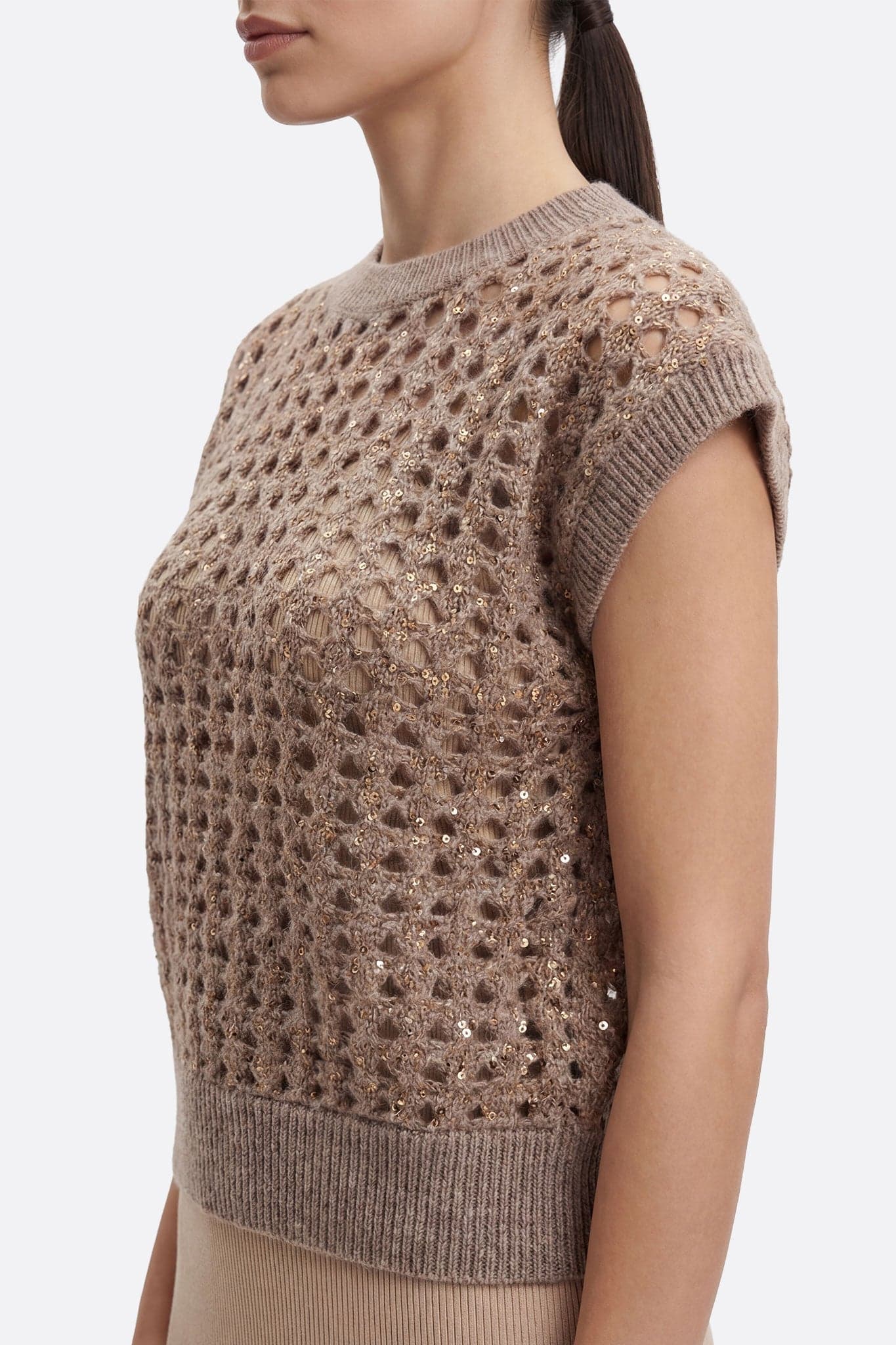 Close-up of the taupe gray sleeveless openwork pullover, highlighting sparkling sequins for a chic and elegant look.
