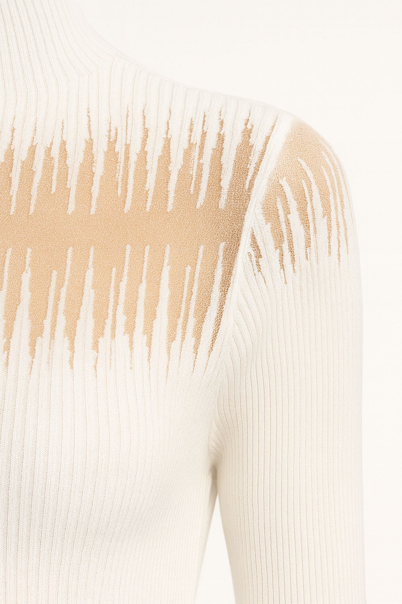 Detail of the back of the fine white pullover, highlighting the ribbed texture and nude yoke for an elegant touch.