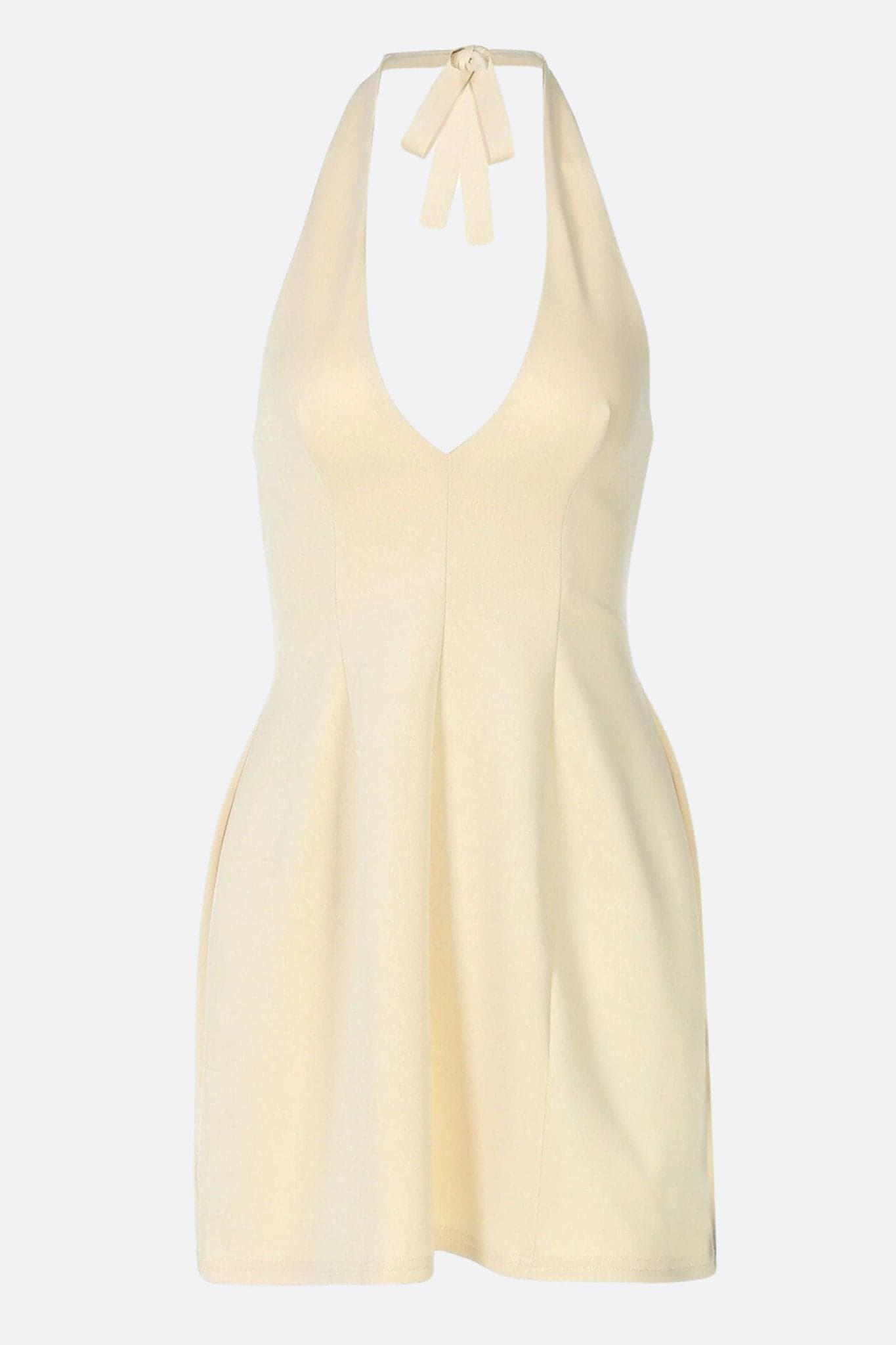 Detalle seductor de un vestido corto evasé beige, destacando la textura delicada y el escote profundo para un look elegante.