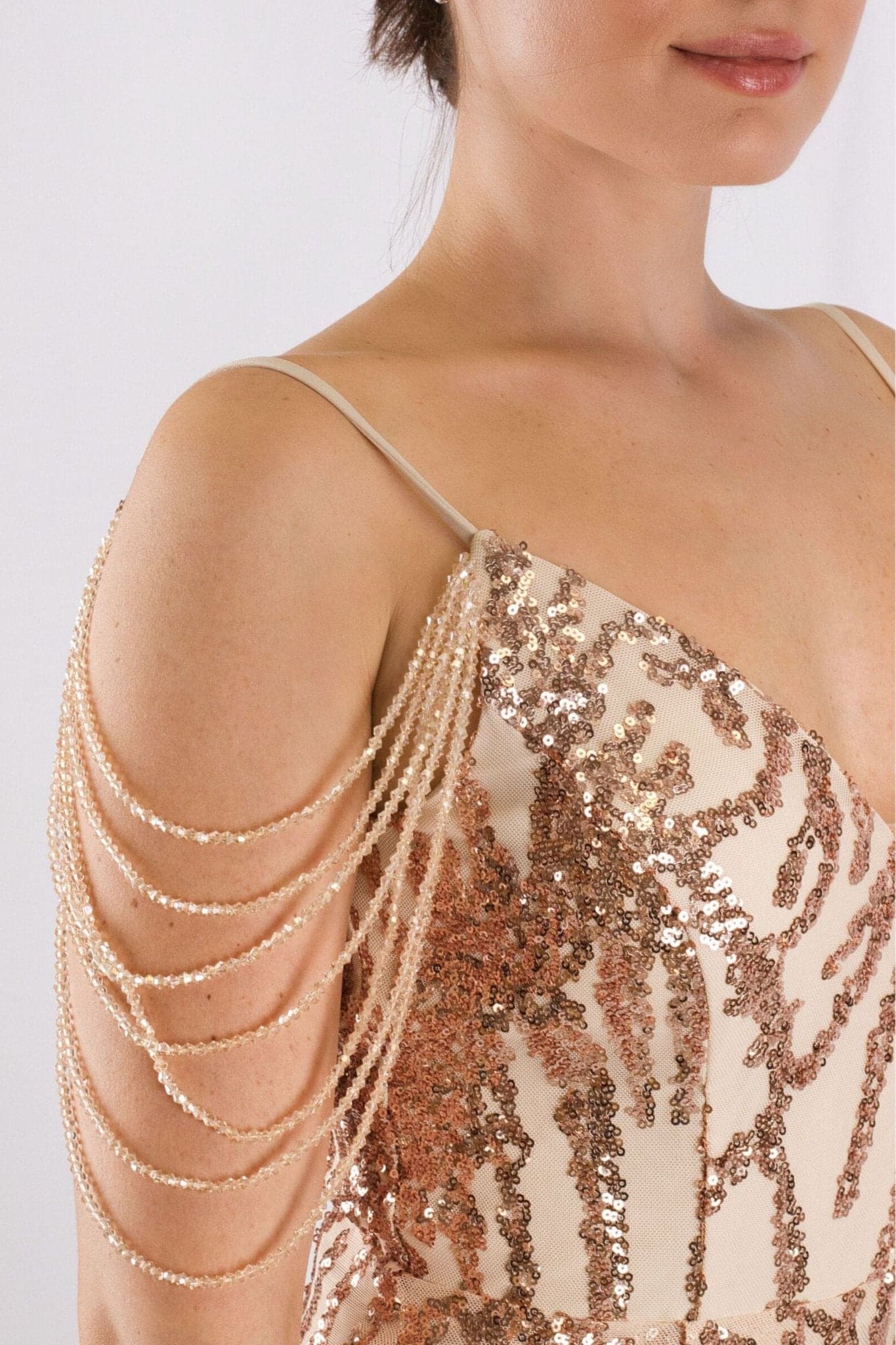 Elegante abito nude con paillettes rosa, vista alternativa che rivela le raffinate maniche a catena perlate per uno stile chic.