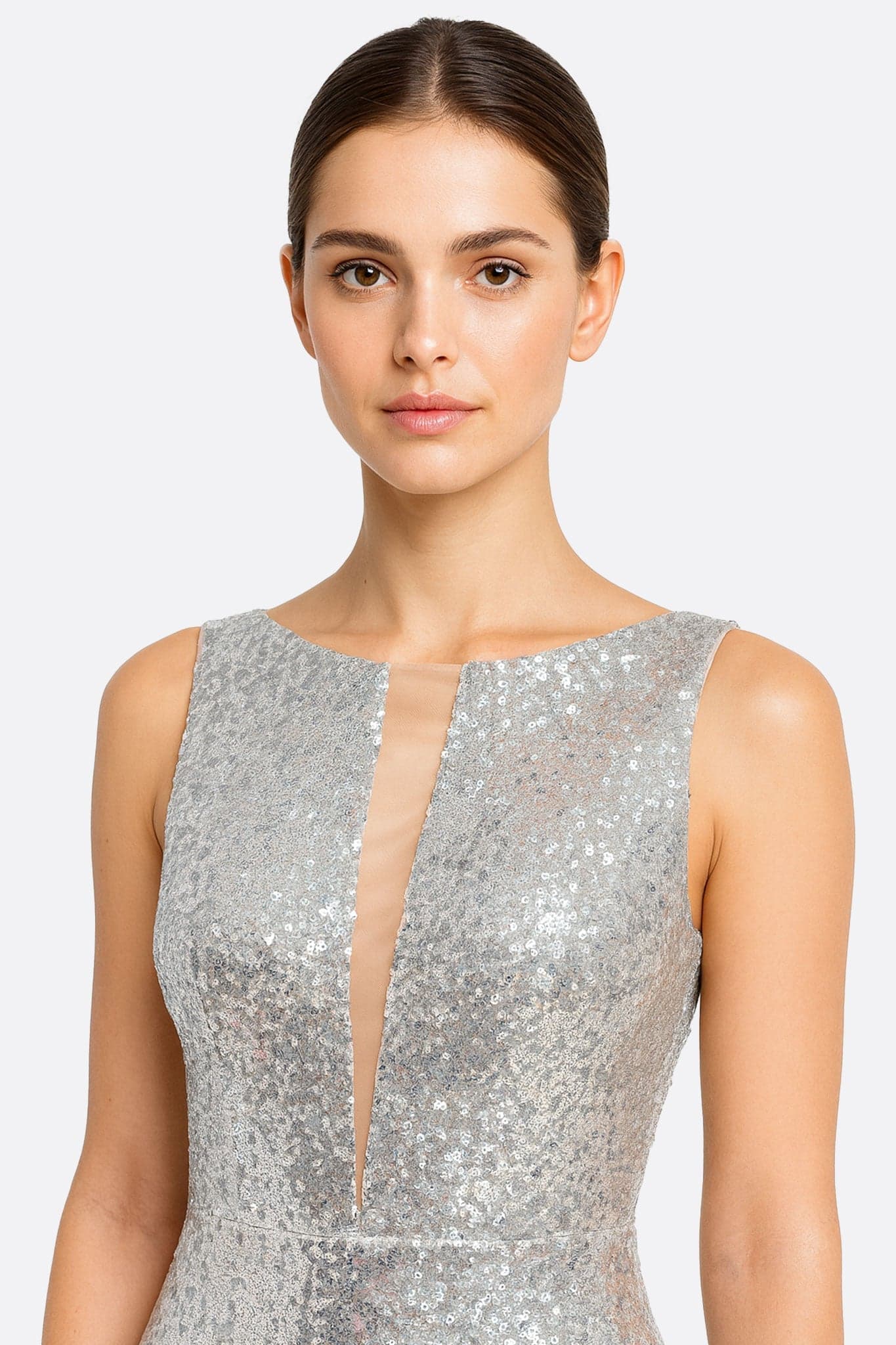 Elegant detail of the long mermaid dress, illuminated by shimmering gold sequins on fine transparent tulle.