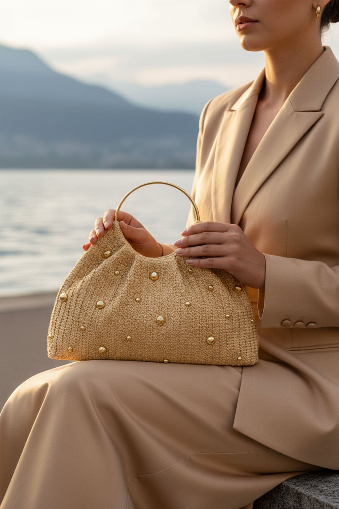 Detail of the golden raffia tote, highlighting the artisanal texture and shiny beads for a summery touch
