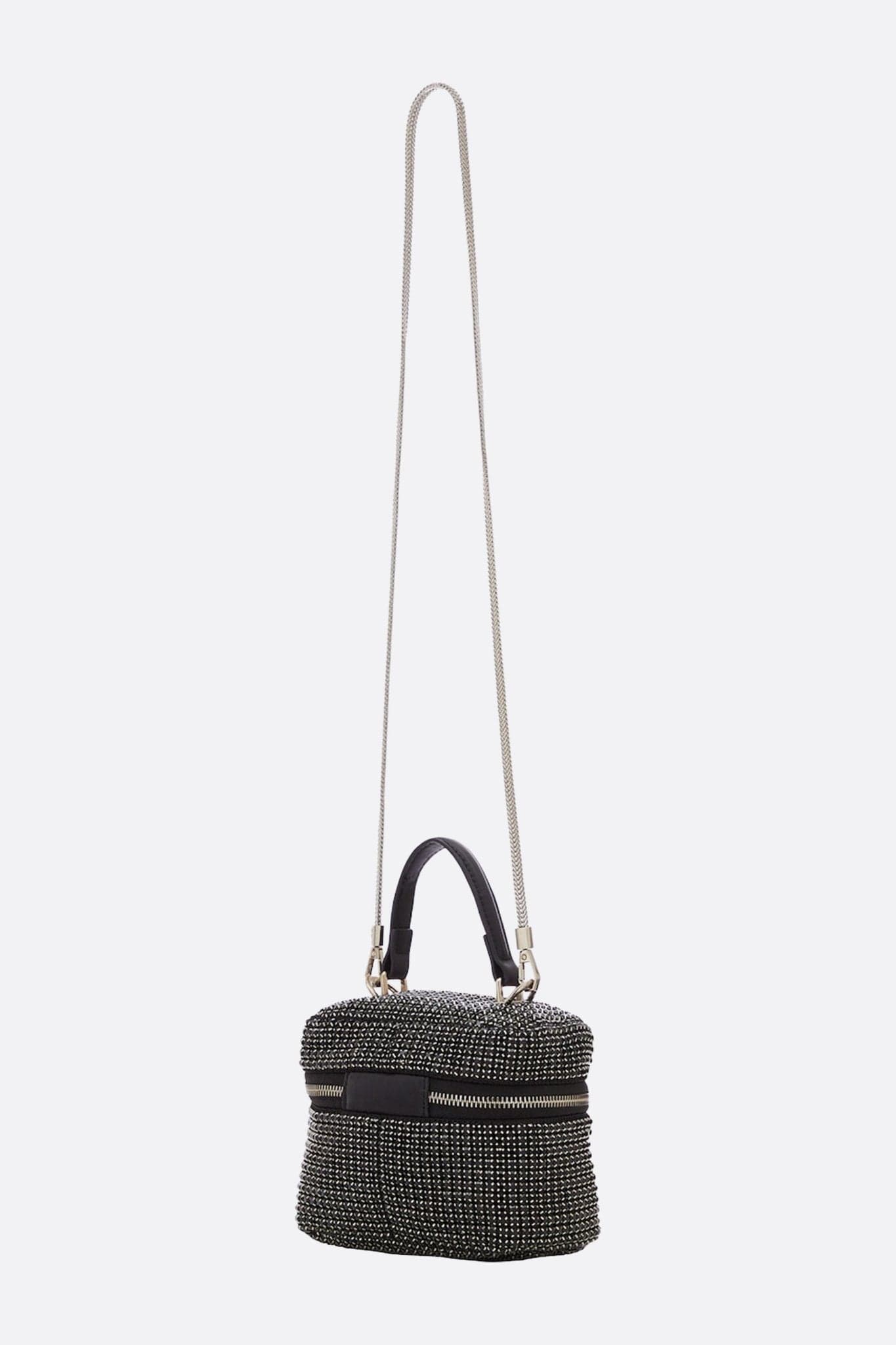 Detail of the compact black crystal evening bag, revealing its sparkling texture and the elegant removable shoulder strap