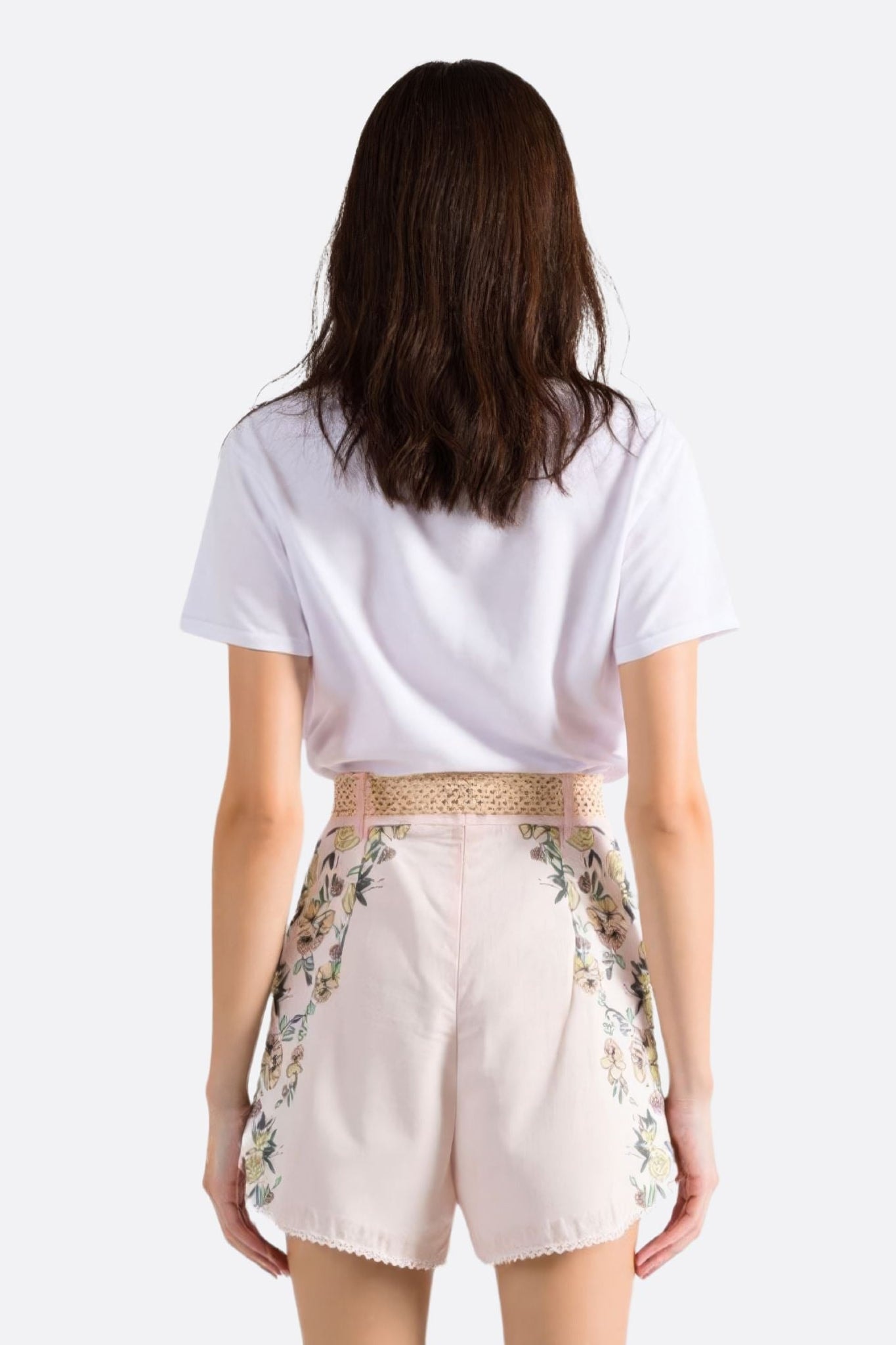 Preview of the pale pink floral print shorts, highlighting its high-waist cut and delicate fabric, perfect for...
