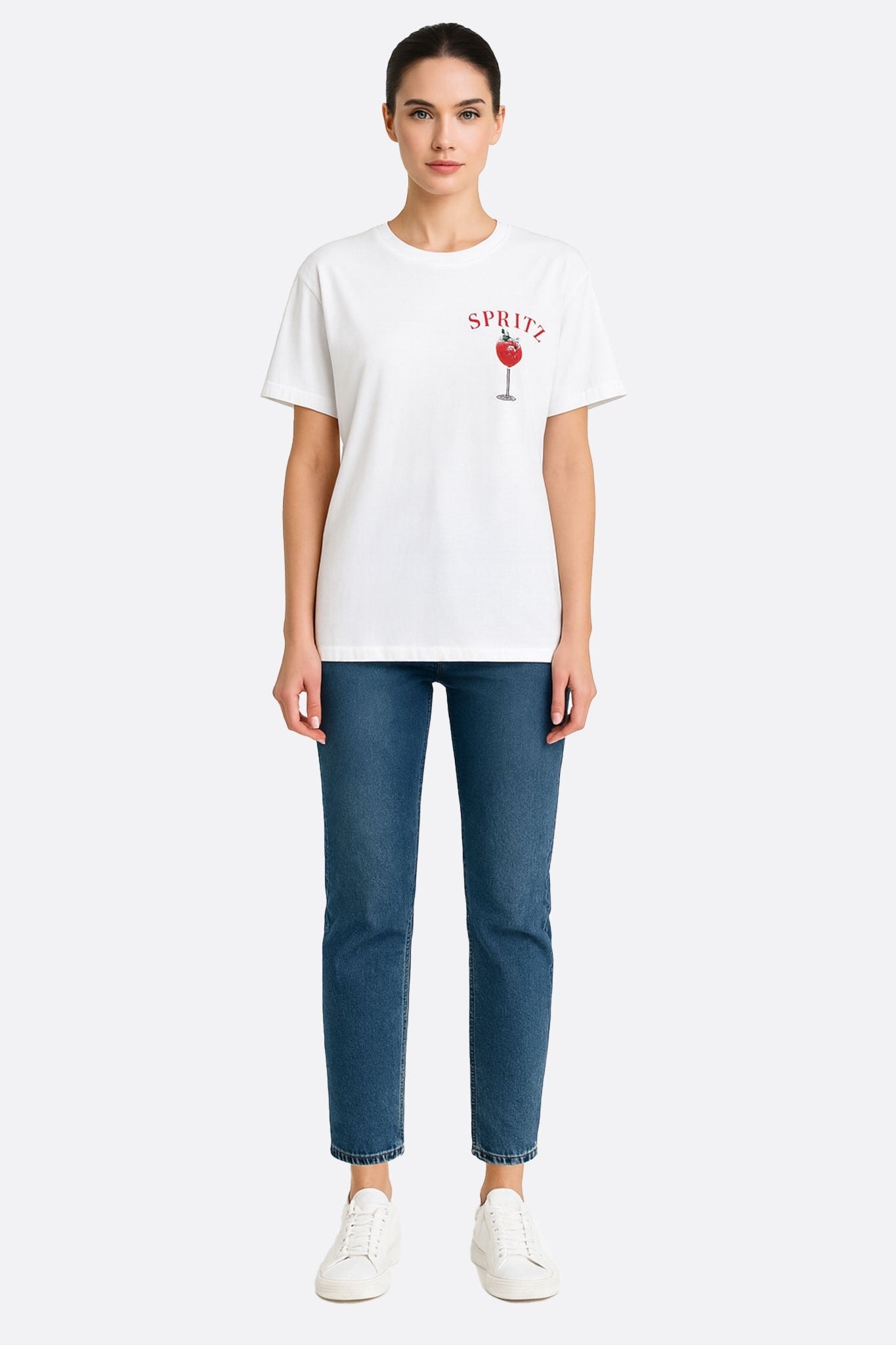 Close-up of the oversized white t-shirt with spritz print, a humorous touch for a casual yet elegant look.