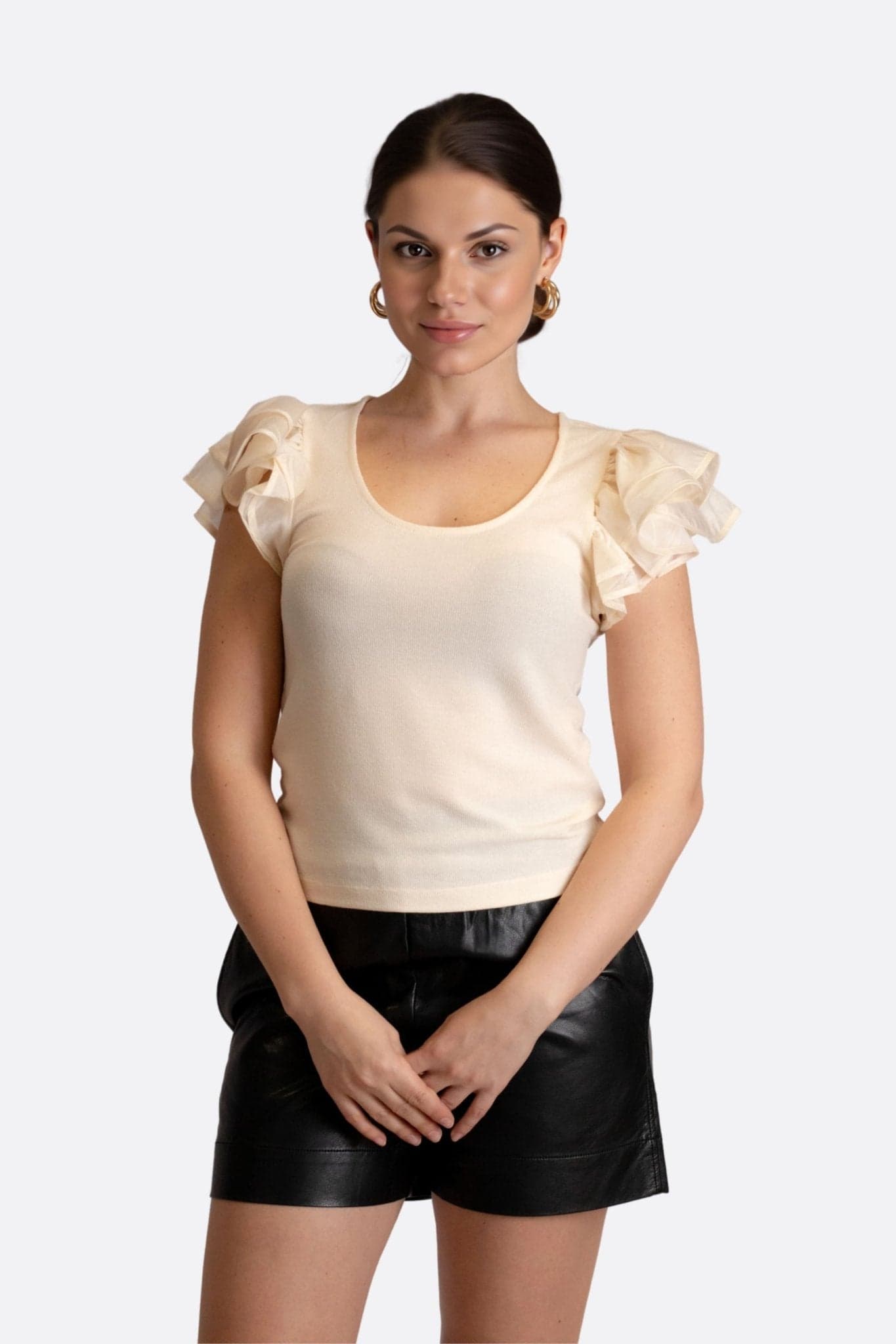 Beige chiffon top with ruffled sleeves, showcasing an elegant silhouette for chic daytime outings or evening events.