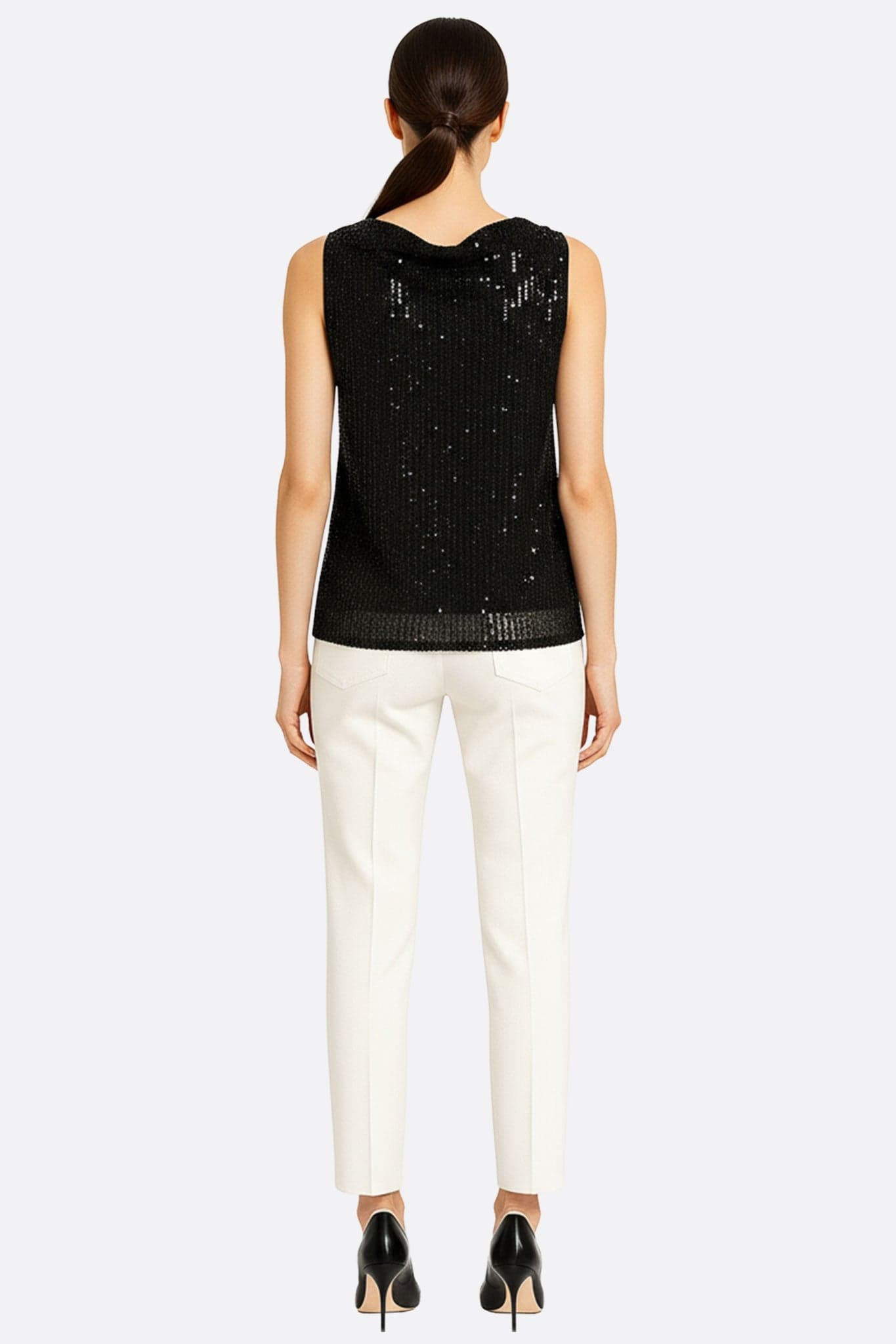 Detail of a black sequined top, highlighting the luminous texture and modern cut for a sophisticated outfit
